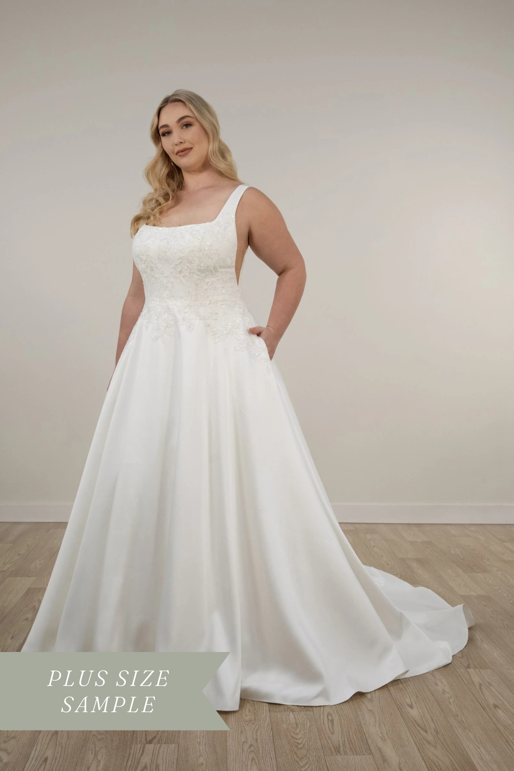 Stella York 7897+ plus-size A-line wedding dress with square neckline, sequin-embellished floral lace bodice, mikado skirt, side cutouts, and hidden pockets