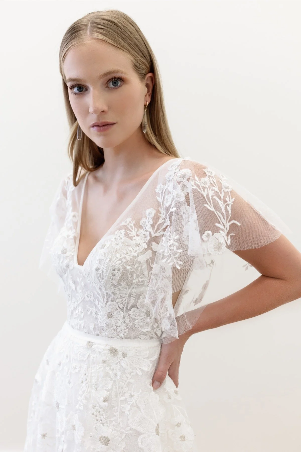 Willowby Finley 50710 A-line wedding dress with metallic floral embroidery, flutter sleeves, V-neckline, and low scoop back
