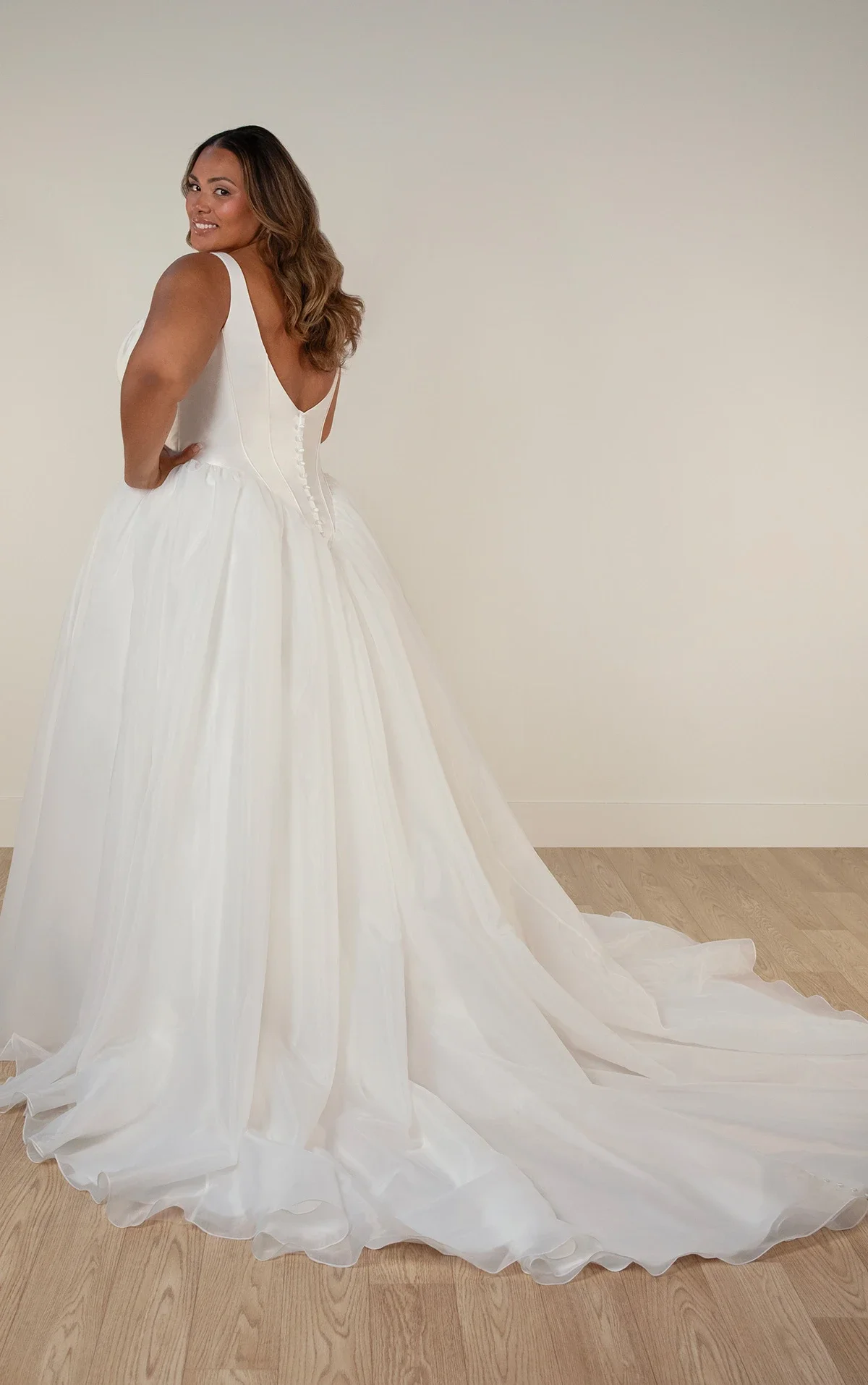 Stella York SY8222+ plus-size ballgown wedding dress with scoop neckline, fitted mikado bodice with basque waistline, and voluminous organza skirt