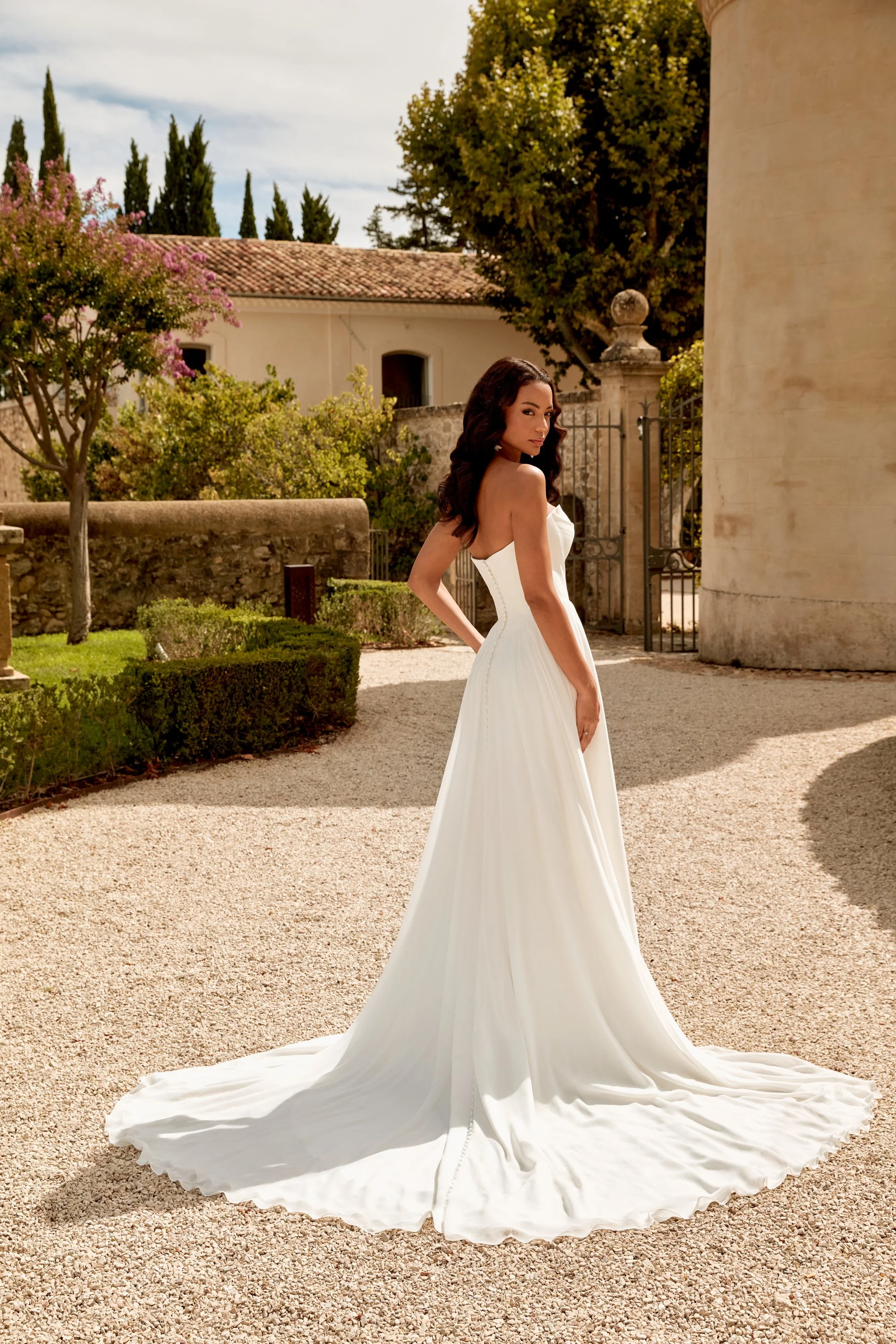 Sincerity 44580 A-line wedding dress with strapless sweetheart neckline, Basque waist, and flowing chiffon skirt