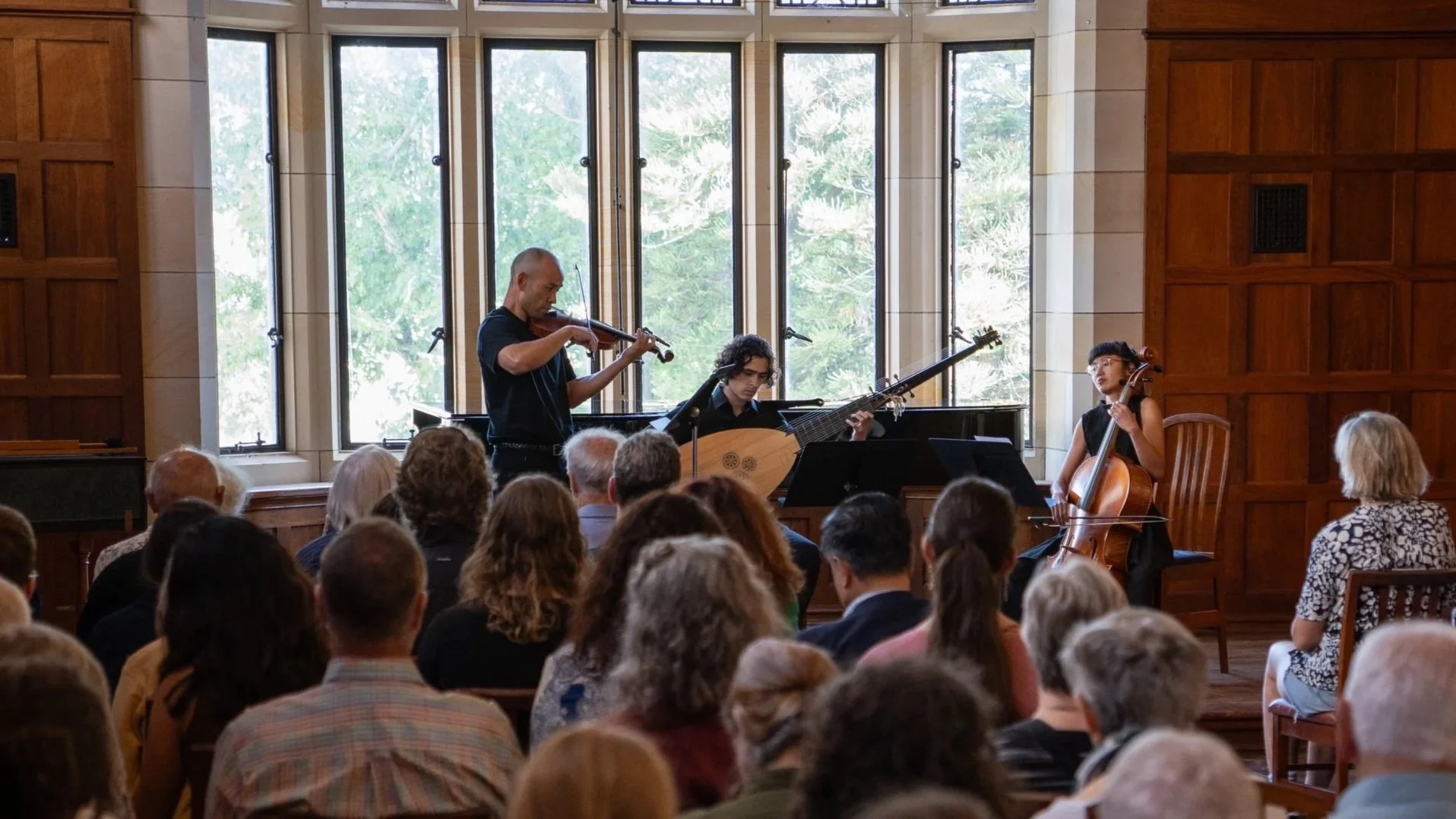 Musicians perform to a seated audience in the Dining Hall at St George's College.