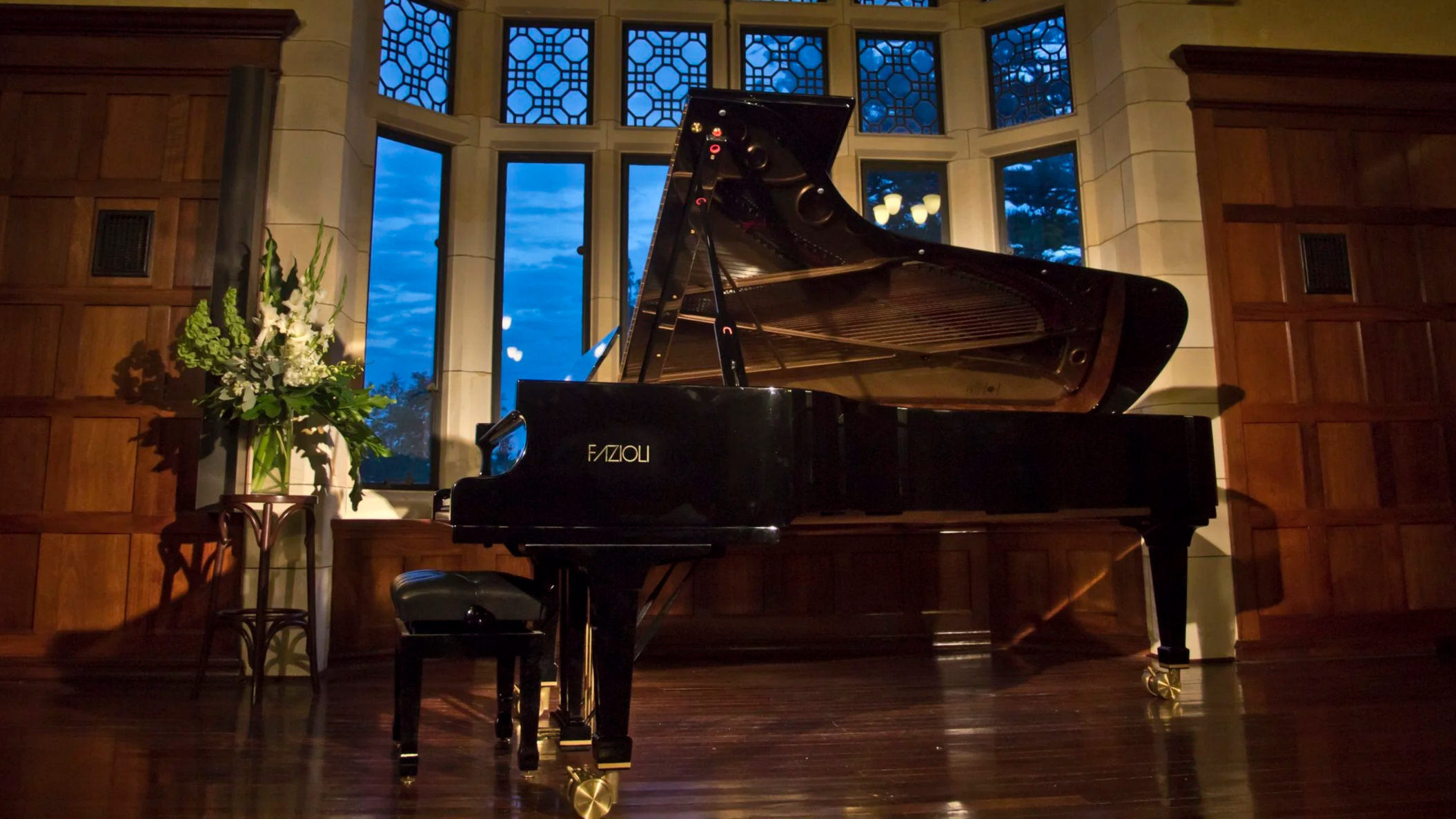 A Fazioli Grand Piano on stage in the Dining Hall of St George's College.