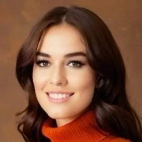 Portrait of a woman with long brown hair, smiling, wearing an orange turtleneck sweater against a brown background.