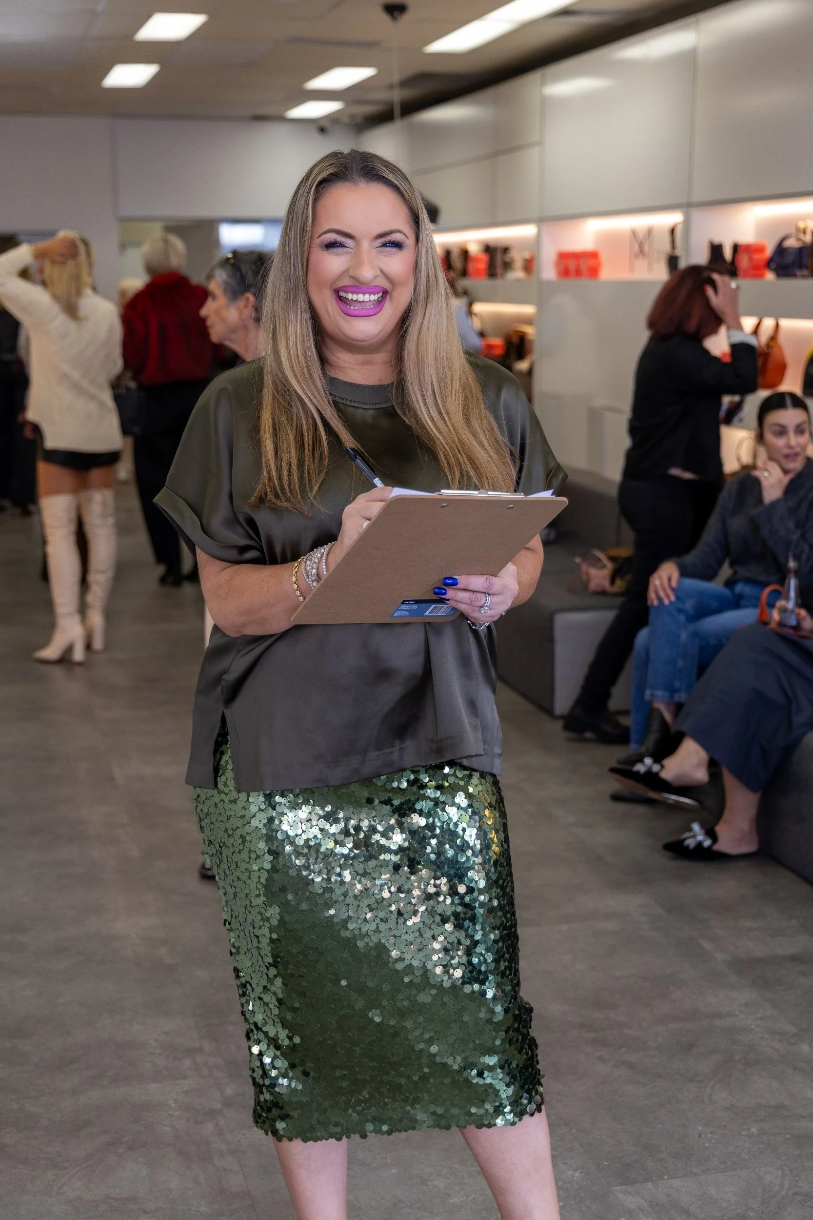 Bernadette Maree, Perth event host, with a clipboard at the front of the Dimario Shoes store launch in Subiaco