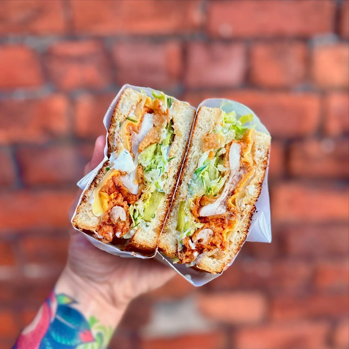 Chicken melt! 🍗🧀

Buttermilk fried chikky, american cheese, mont jack, shreddice, house pickles &amp; parm ranch. In a sando 🥪 

Get it now! 
@ro.heaton