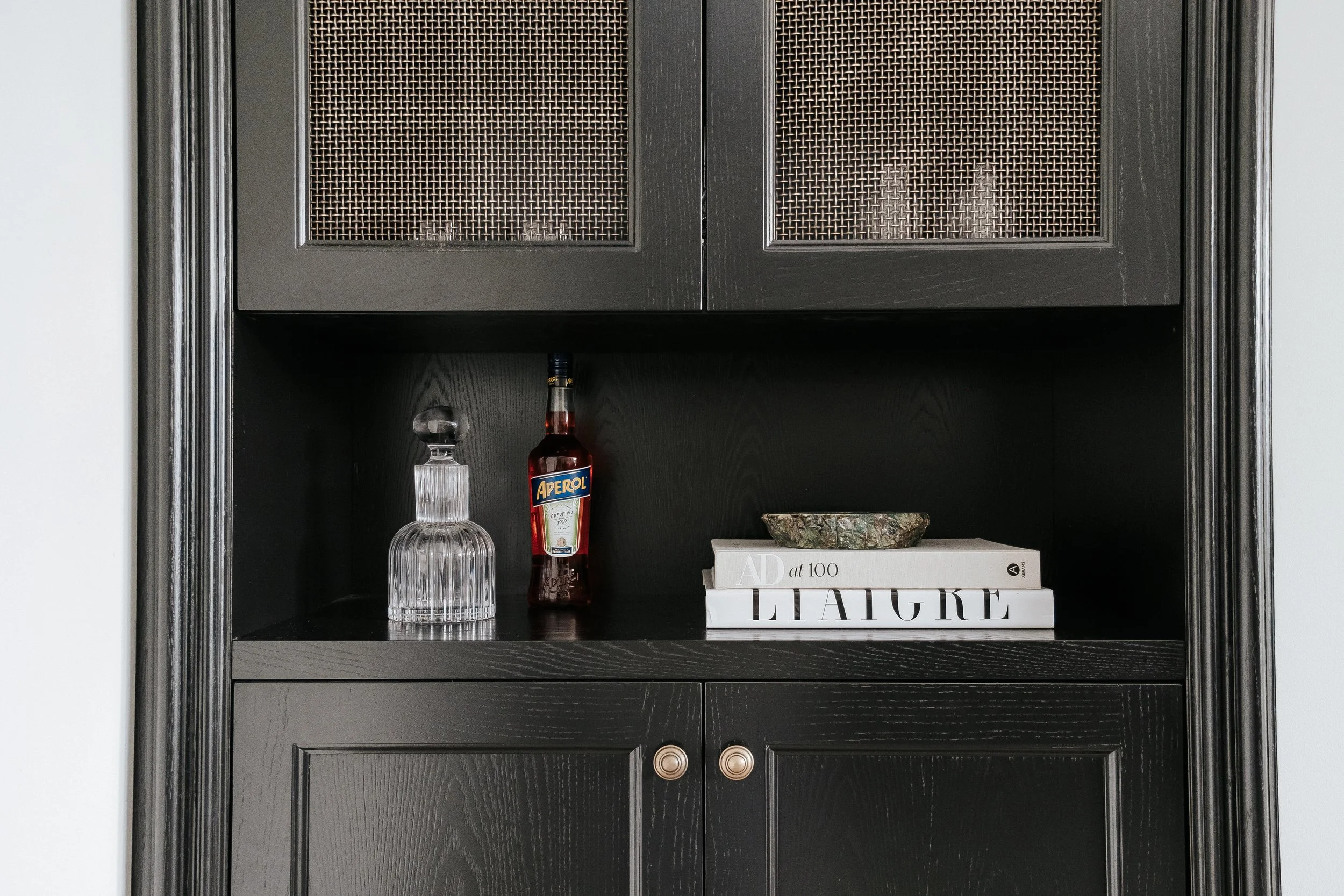 Custom cabinetry with concealed storage and integrated technology designed in Perth. 