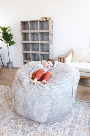 Lifestyle photo of a boy curled up on a Platinum Haven.