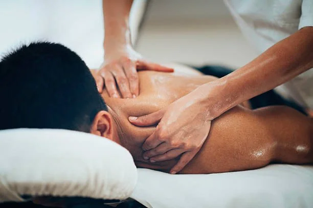 Person receiving a massage on their back in a spa setting. essex holistic therapy massage
