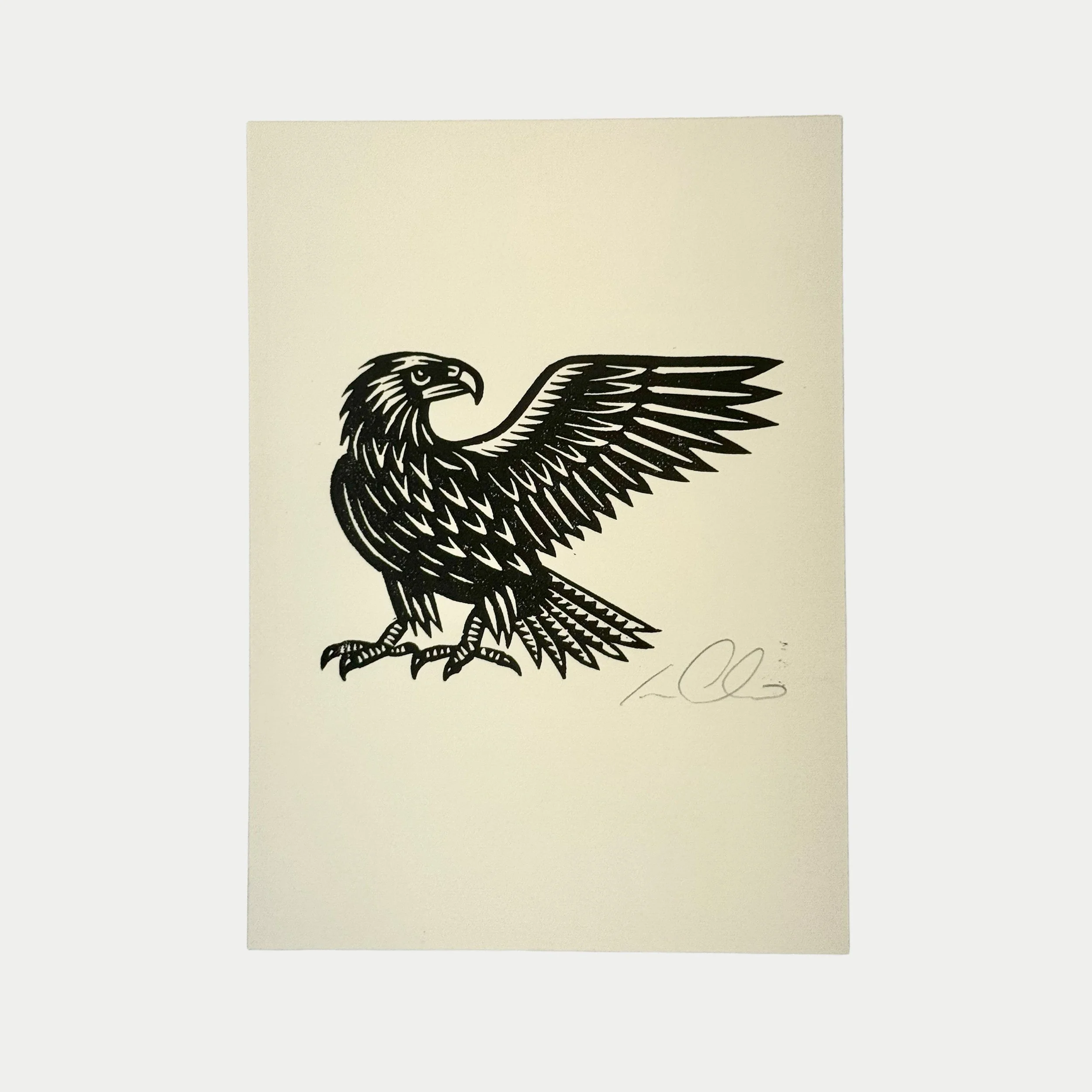 Black illustration of a fierce-looking eagle with wings spread, facing to the left, on a white background.