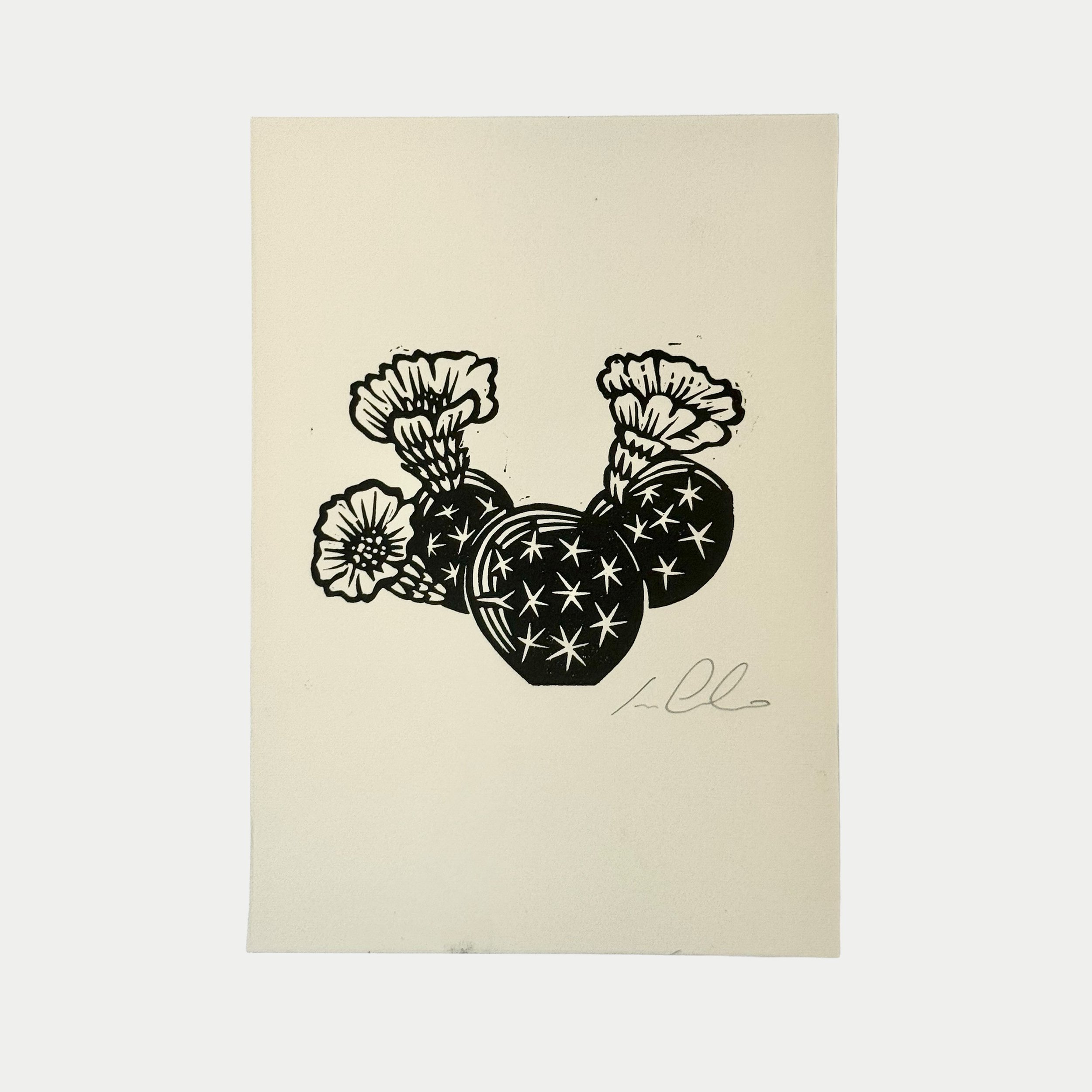 Black and white illustration of strawberries with flowers, signed in the bottom right corner.