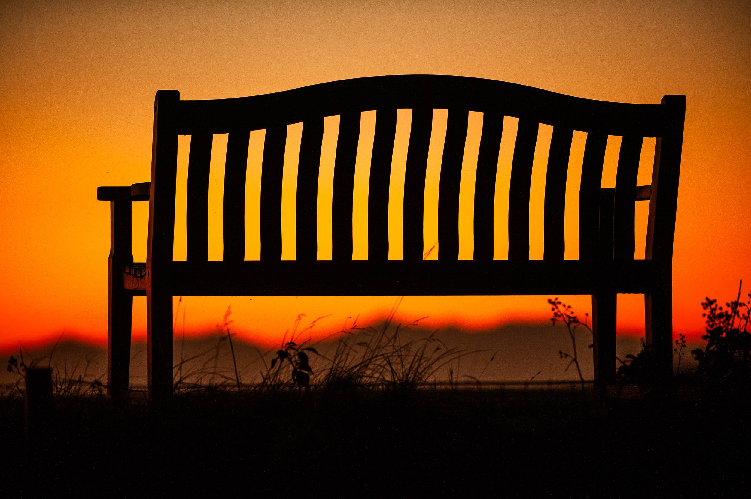 'Chair To The Setting Sun' fine art photograph in Ayrshire with Arran in the background.