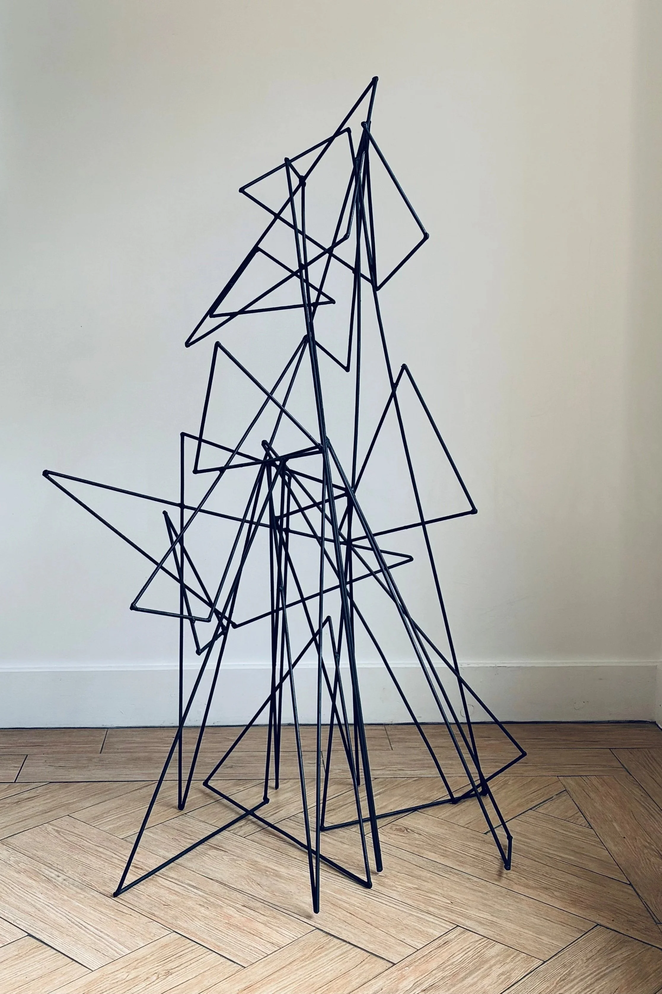 Stacked triangles, mild steel, paint.