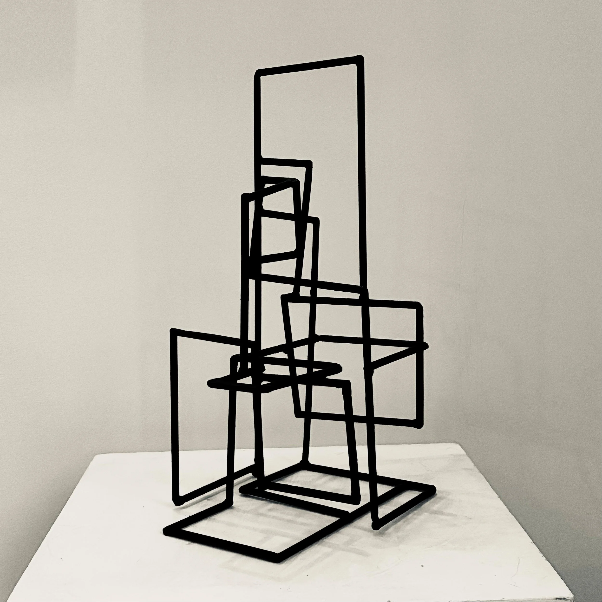 With four sides, mild steel, paint.