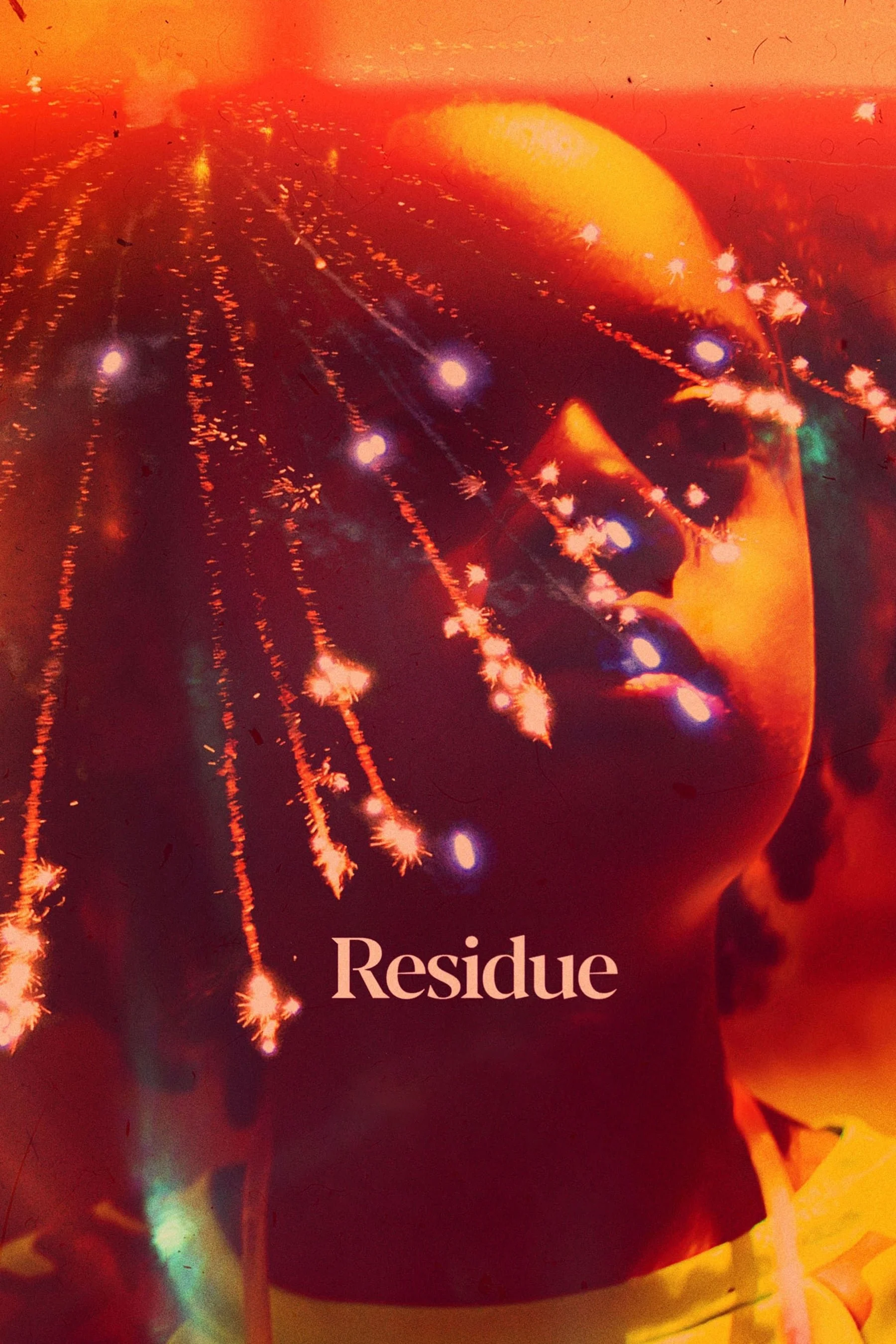 A person with fireworks reflected on their face, with the word 'Residue' printed at the bottom. DILLIES