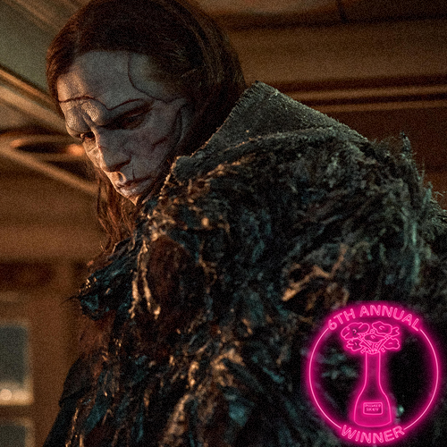 Young woman dressed as a princess, wearing a tiara and blue gown, looking down thoughtfully. A badge in the bottom right indicates she is a winner of the 5th Annual Dillweed Society Excellence in Film Awards.