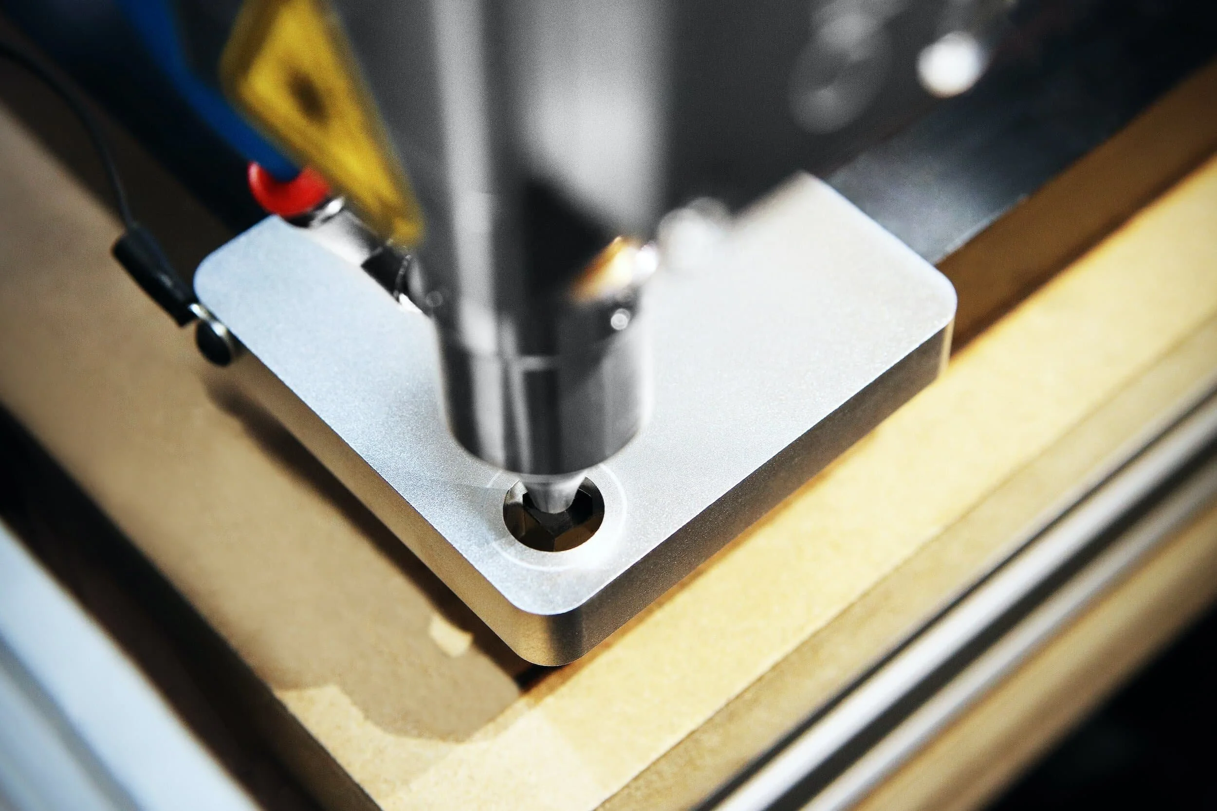 Close-up of a CNC machine drilling into a metal workpiece.