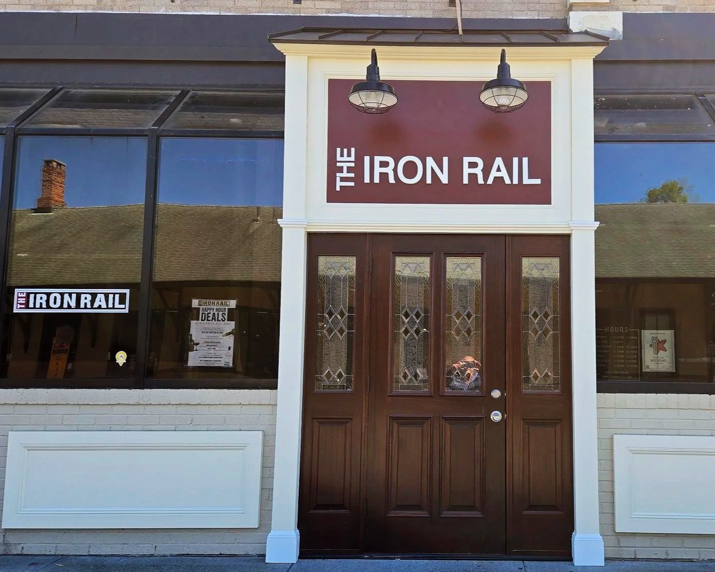 the front door and new signage of The Iron Rail a bar in downtown New Milford