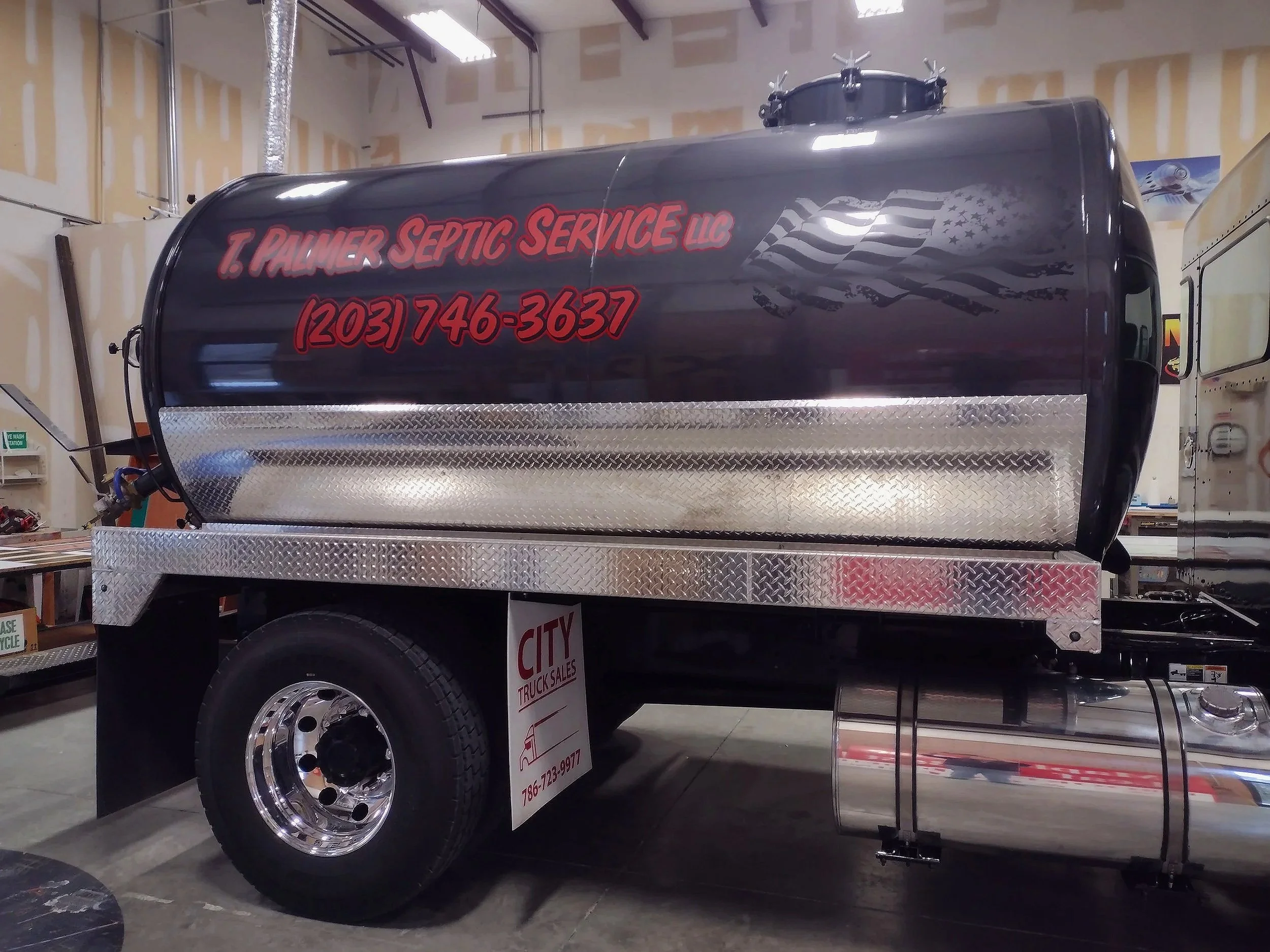 T.Palmer Septic Truck with new Graphics on the tank, red writing on a black tank with the subtle hint of an American flag decal in the black.