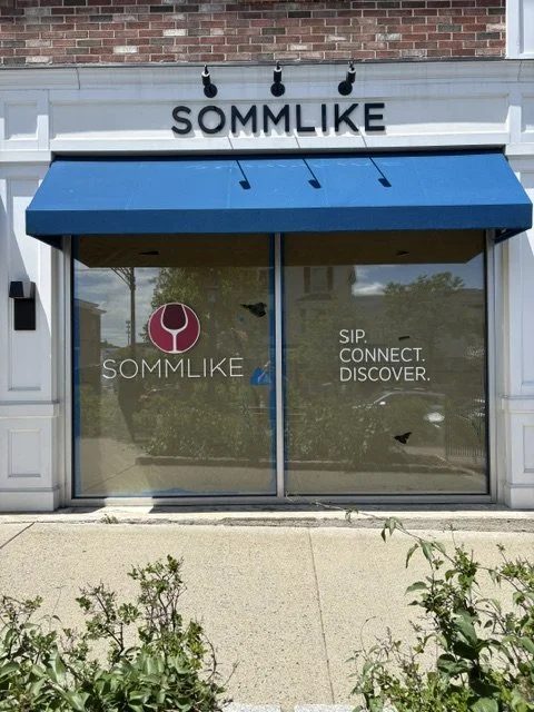 Sommlike Store front with signage work above the awning and on the two glass windows in front