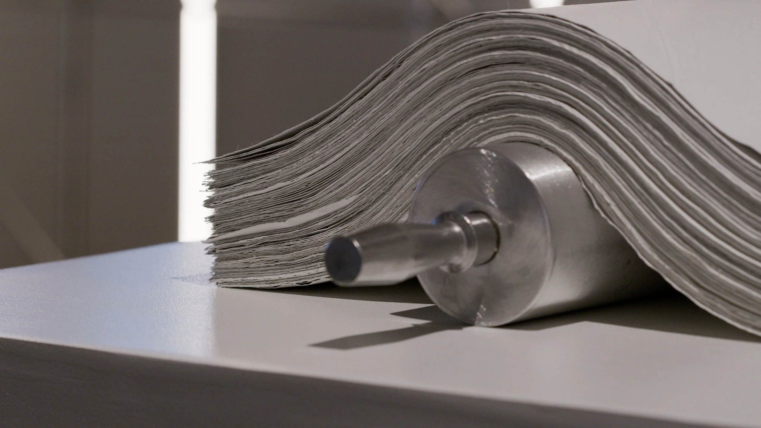 paper-like sculptural material layered on aluminum rolling pin sculpture, papers carry DNA fragments for grandmother, mother and daughter.