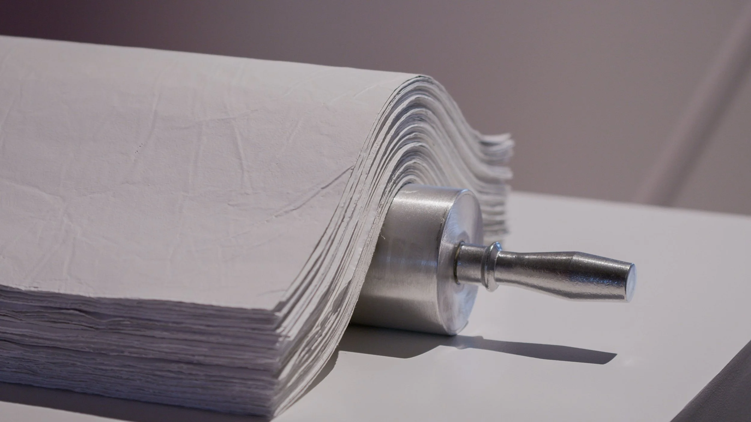paper-like sculptural material layered on aluminum rolling pin sculpture, papers carry DNA fragments for grandmother, mother and daughter.