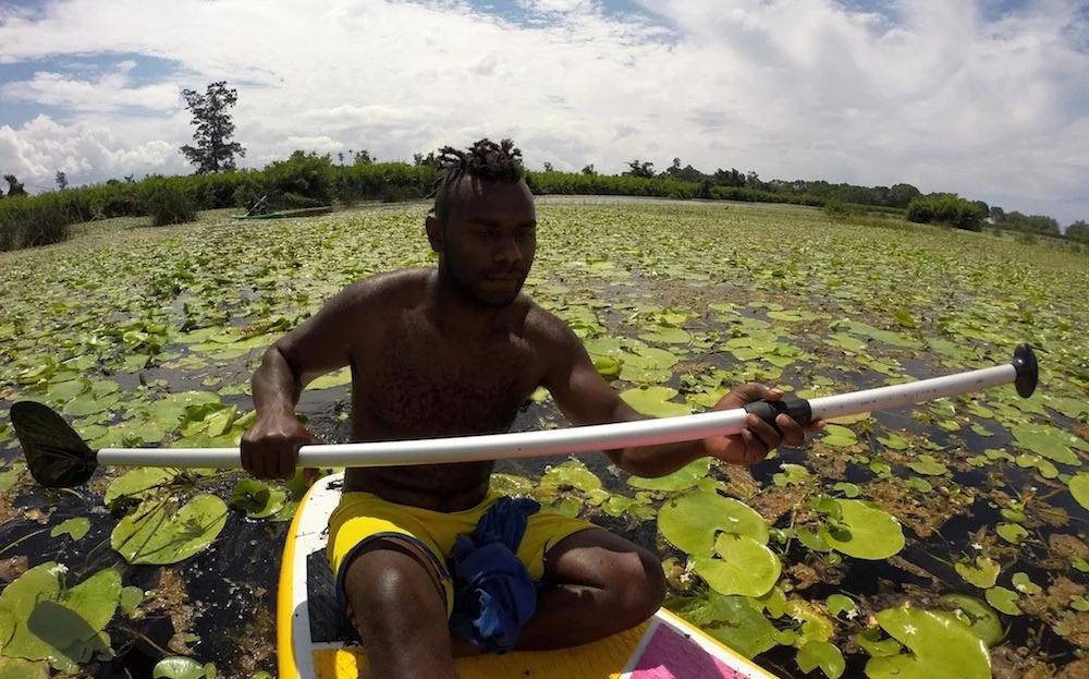 ni-vanuatu-man-paddling-through-the-lilies-at-big-bay-espiritu-santo-vanuatu.jpg