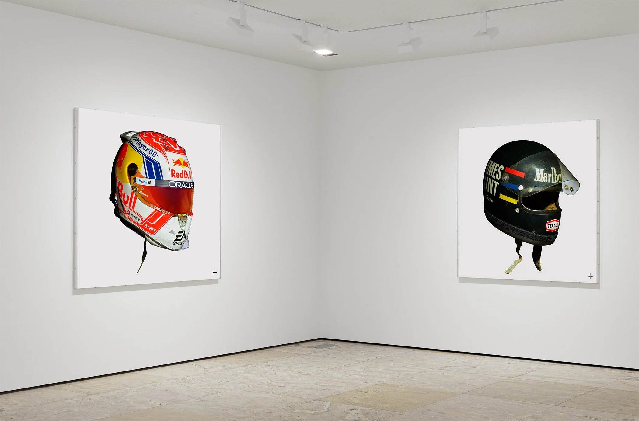 Fine art print installation view showing race-worn helmets by Max Verstappen and James Hunt, from Legacy+Art's 'The Art of Racing' collection. Limited edition 60"x60" prints.