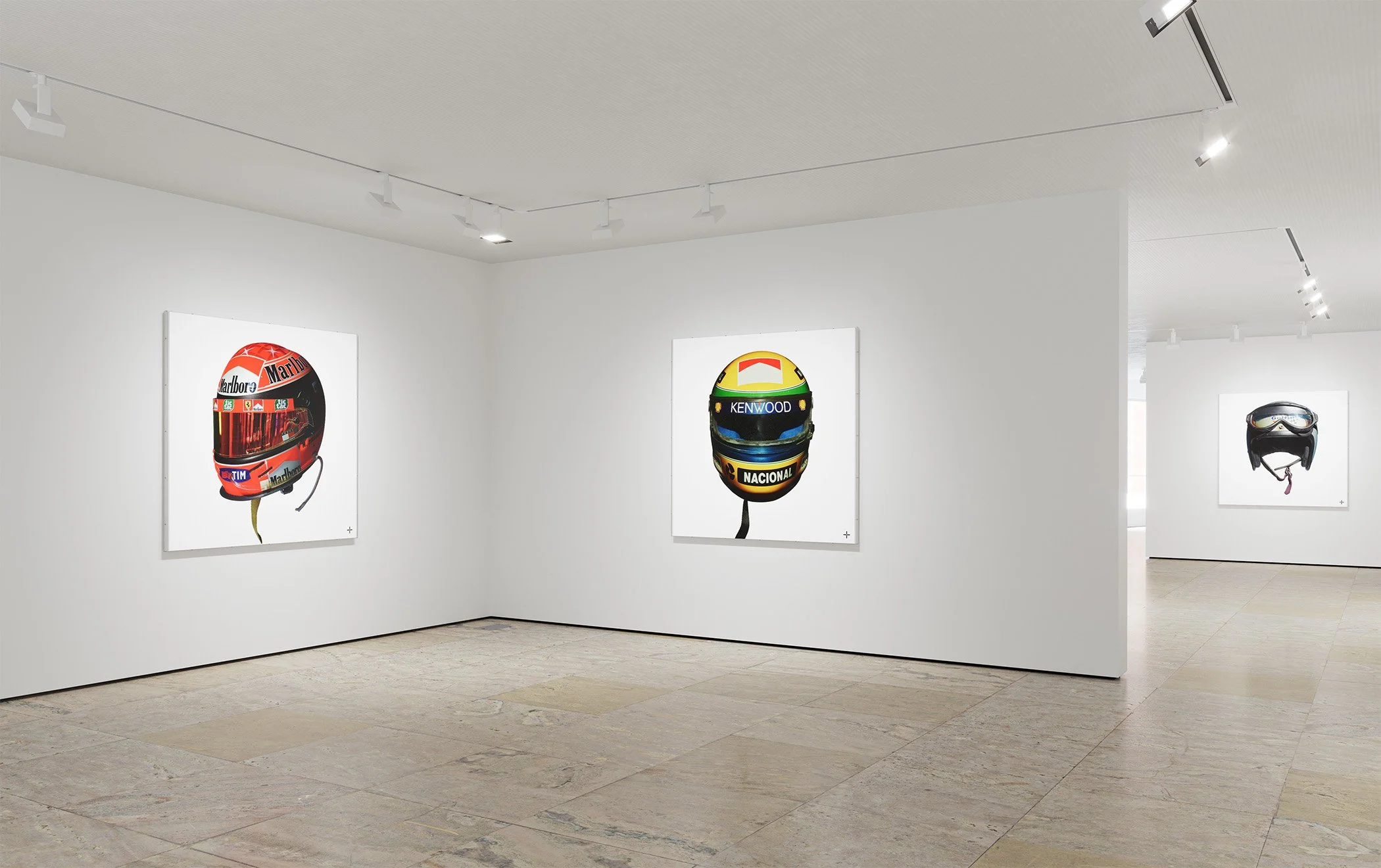 White Cube gallery space with fine art prints of Grand Prix winning Formula 1 race worn helmets belonging to Schumacher, Senna and McLaren. Visually striking artworks of iconic race helmets available for all dedicated fans of motor racing.