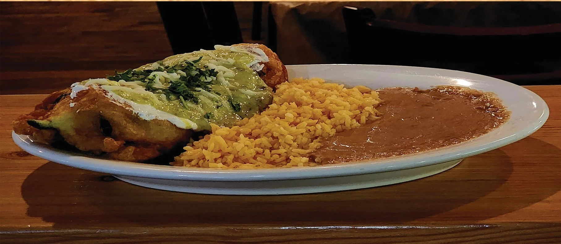 Chile Relleno Topped with our house made creamy tomatillo sauce Mexican rice, and refried beans.