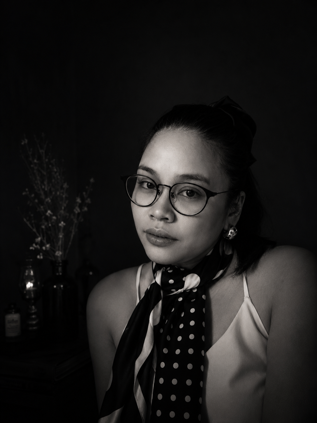 Black-and-white portrait of Madame Rberry wearing glasses and a patterned scarf.