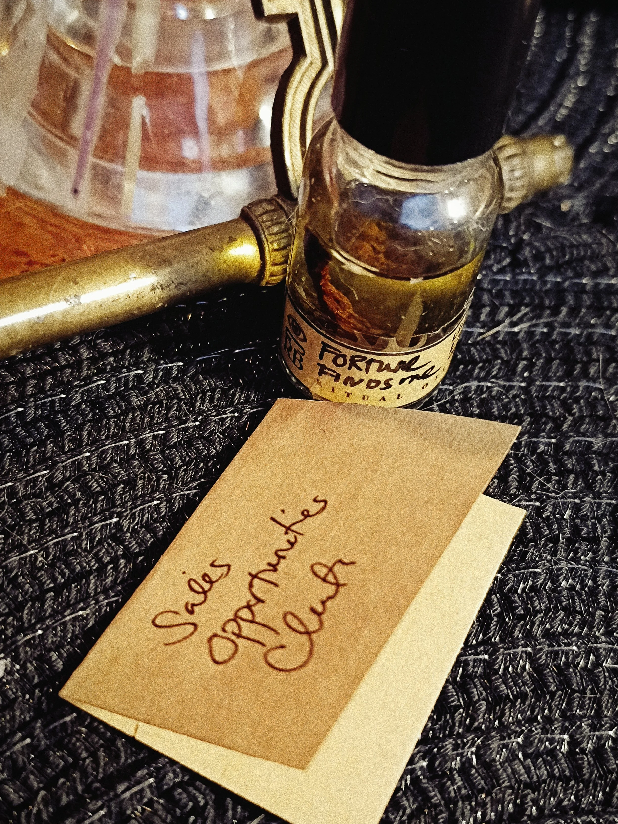 Fortune Finds Me Ritual Oil beside a handwritten prosperity petition