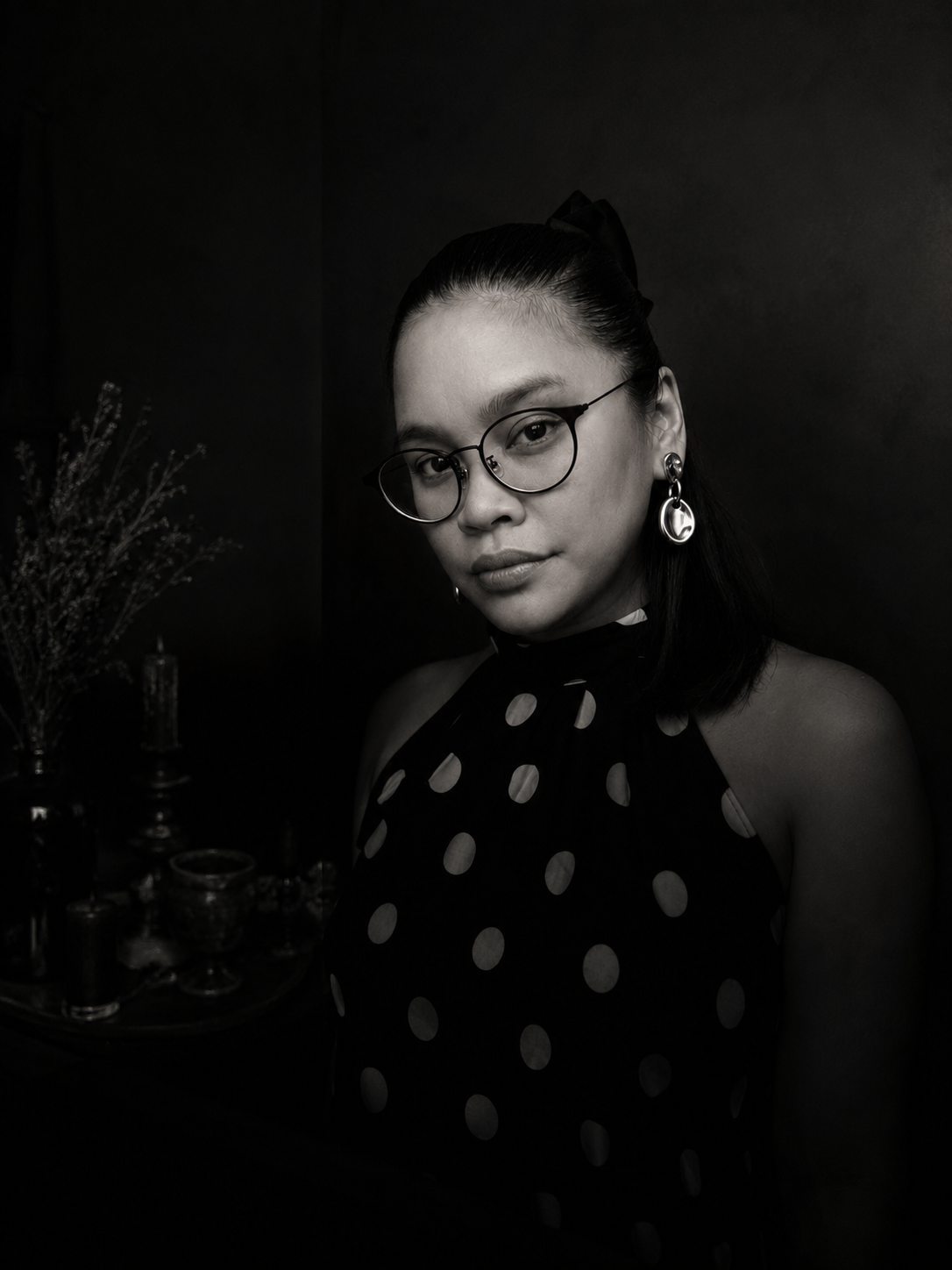 Black-and-white portrait of Madame Rberry beside her workbench altar.