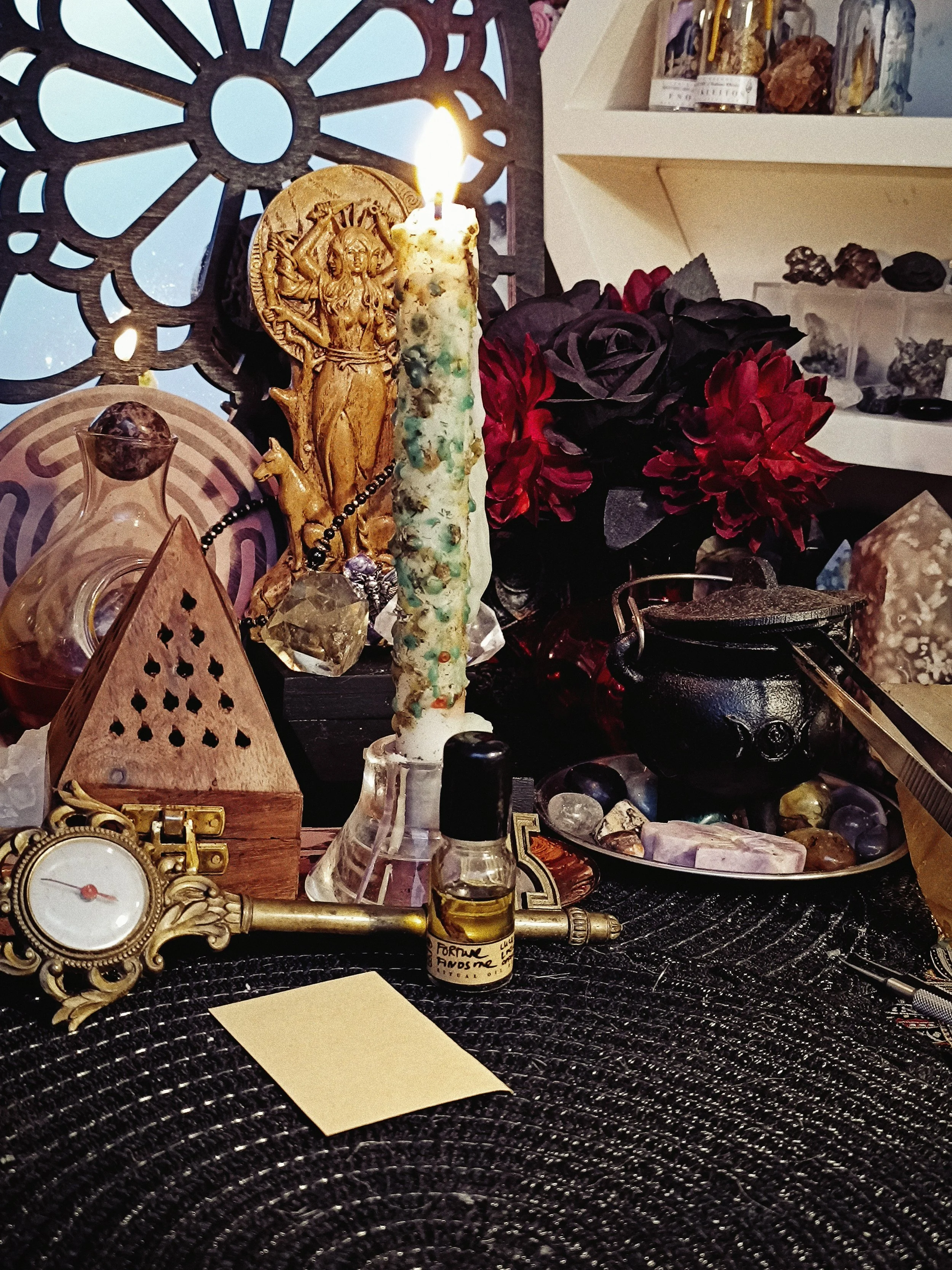 Big Fortune Energy Set with herb-dressed white taper candle and Fortune Finds Me Ritual Oil on an altar