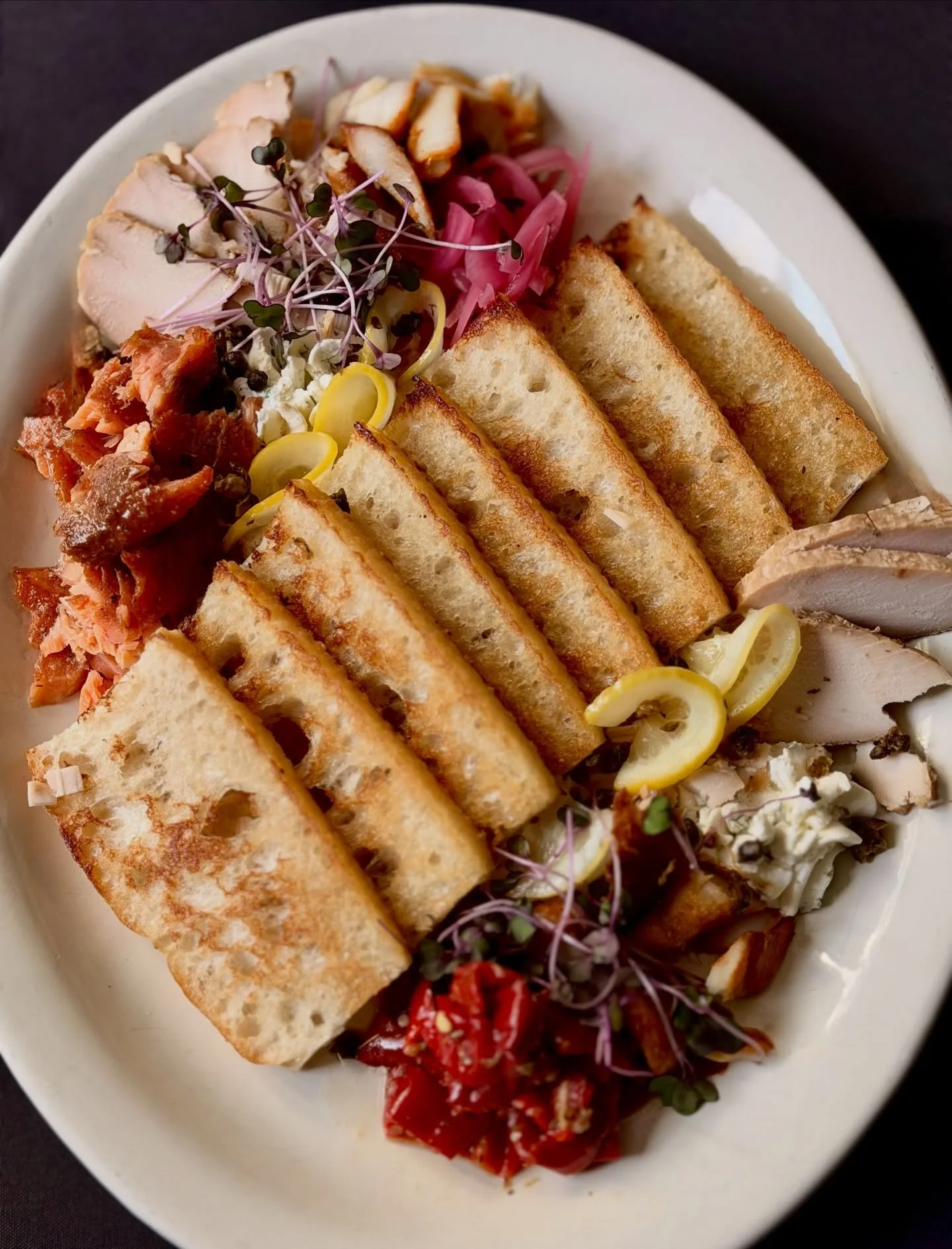 Right now, we&rsquo;re highlighting all local catch on our Smoked Fish Platter- Smoked salmon, black cod and albacore. Each with its own depth and texture gently smoked and served with herbed cream cheese, pickled onions, capers and crostini.