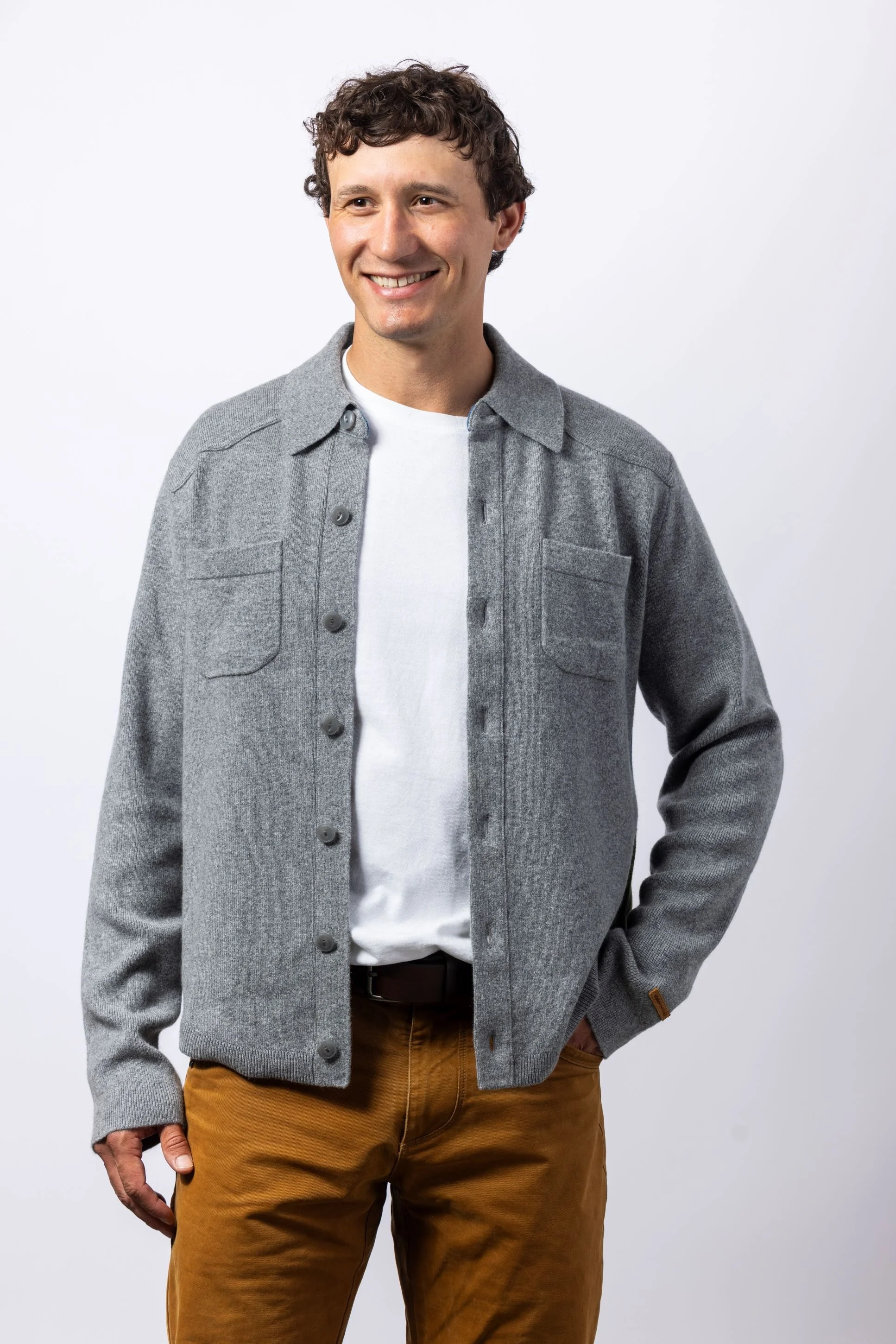 Man in a studio wearing a grey button down flannel cashmere shirt