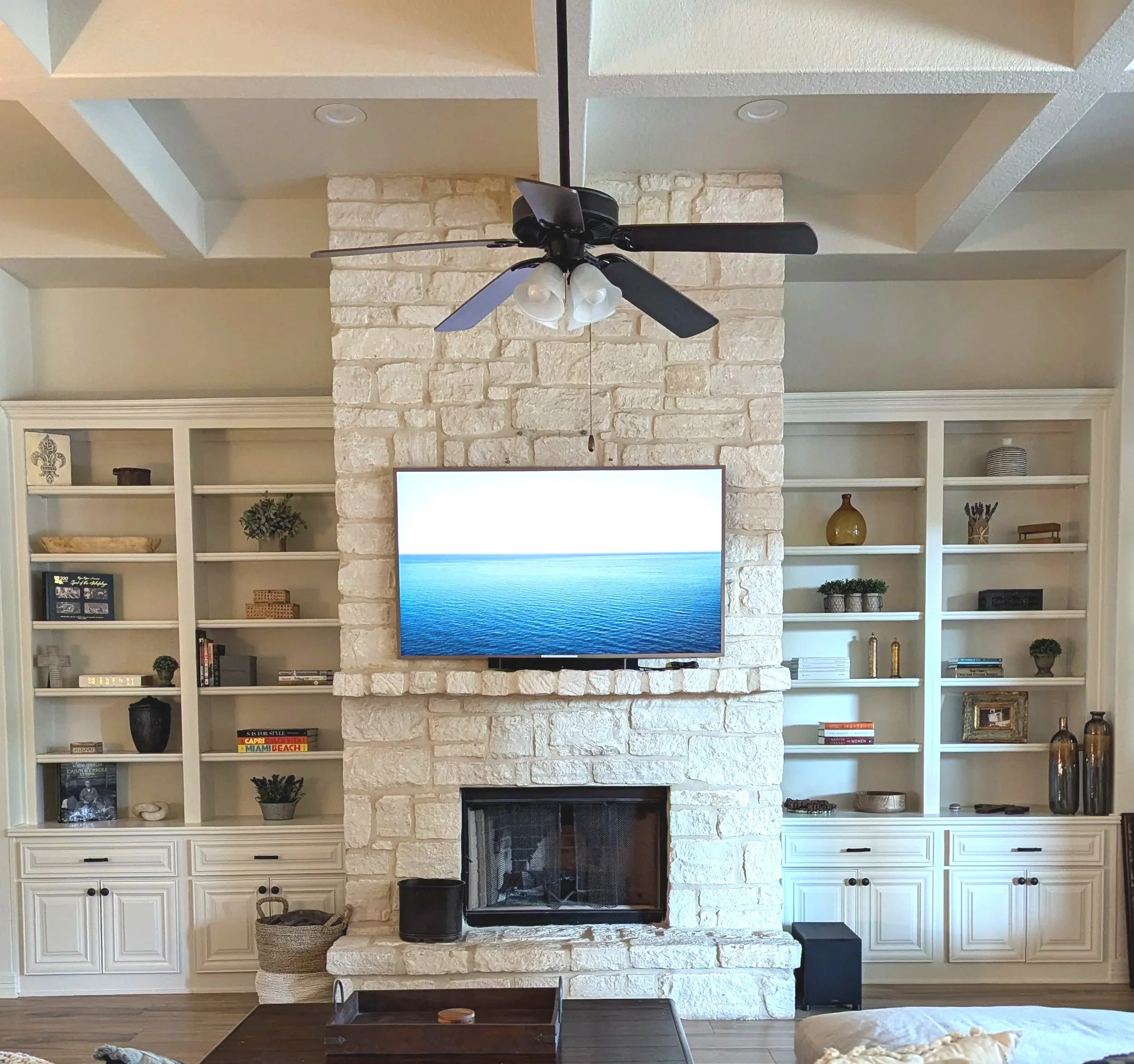 a living room with organized shelves of knick knacks