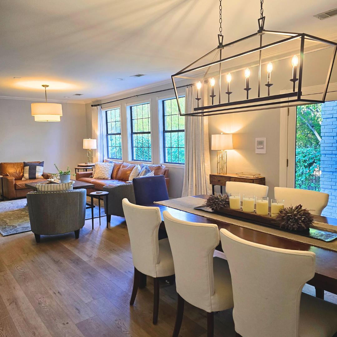 a large view of a dining room flowing into a living room that looks elegant and clean