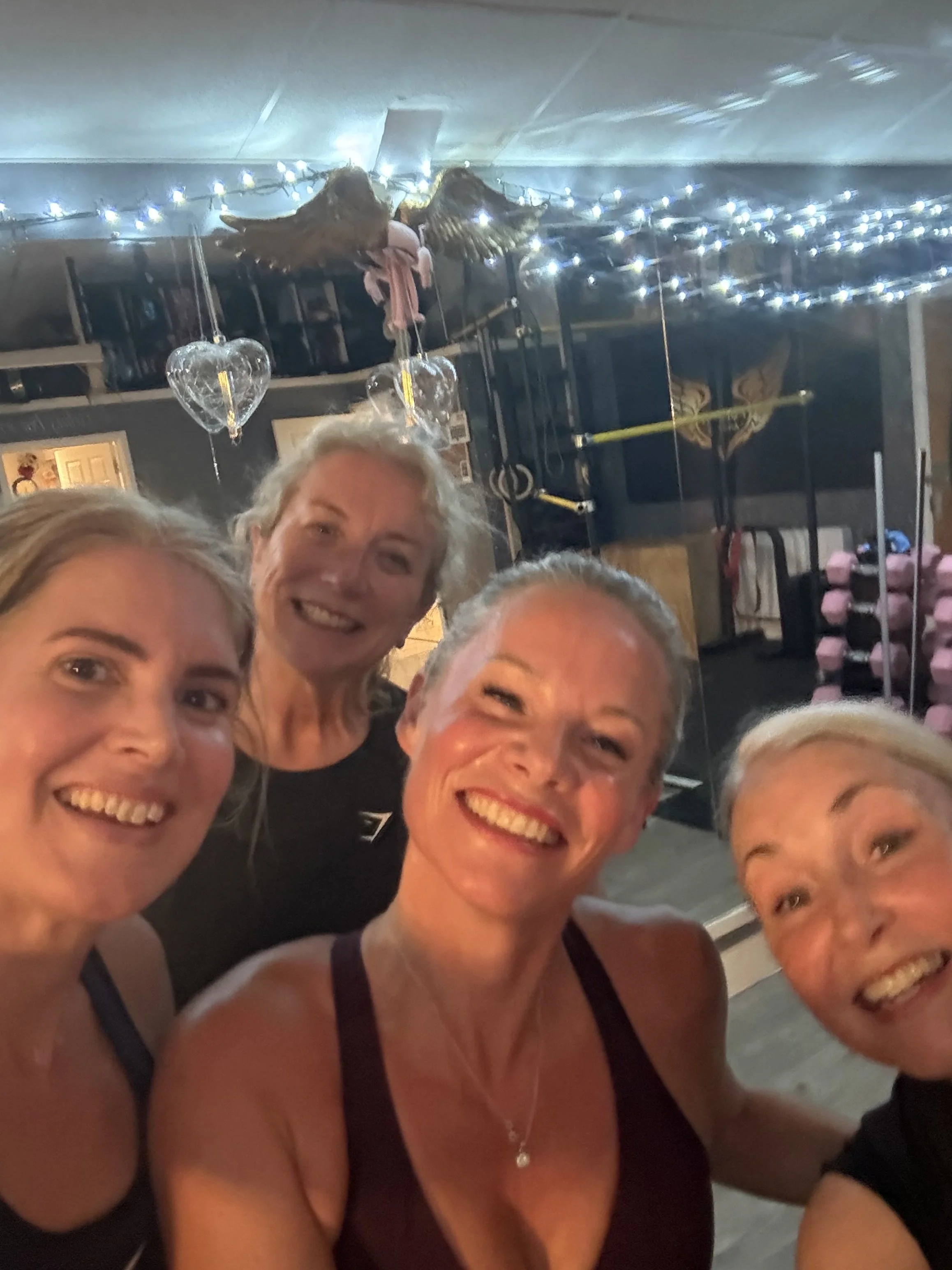 4 ladies looking into the camera after a hot workout