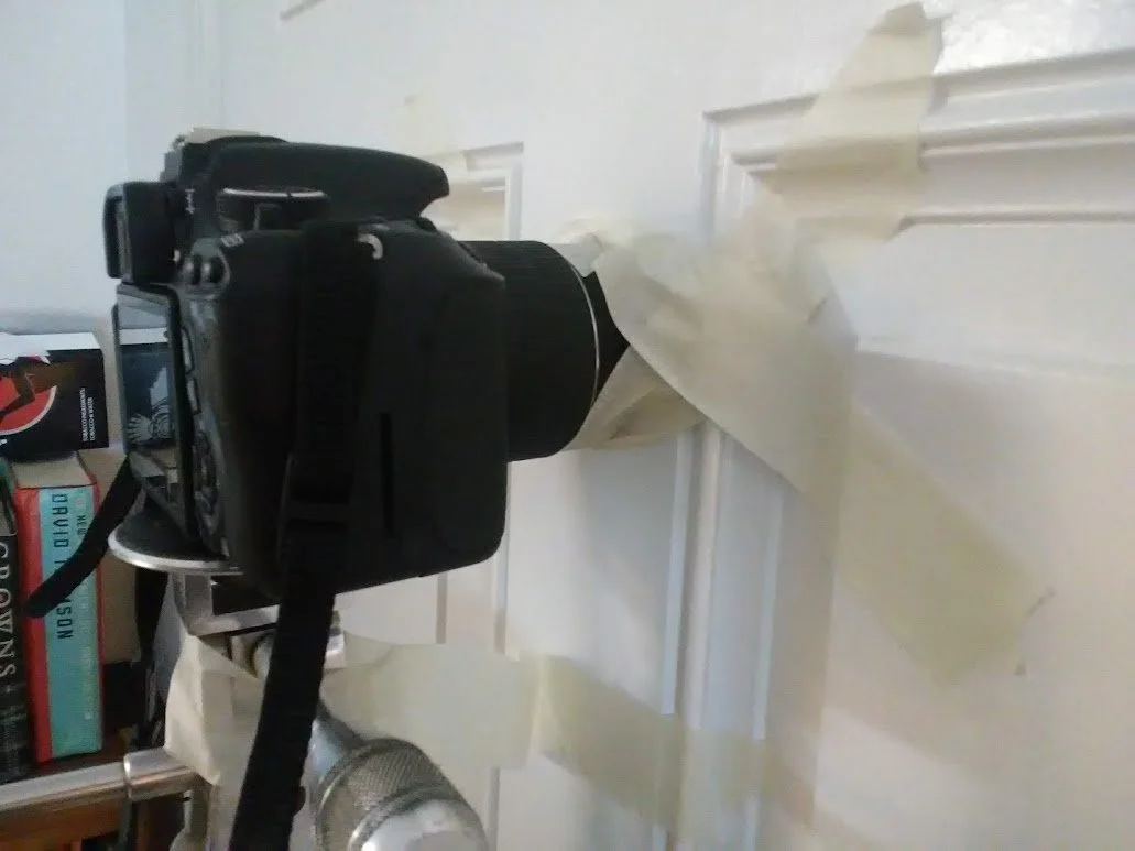 DSLR camera taped and secured against my front door to get the "keyhole" shots of Larry.
