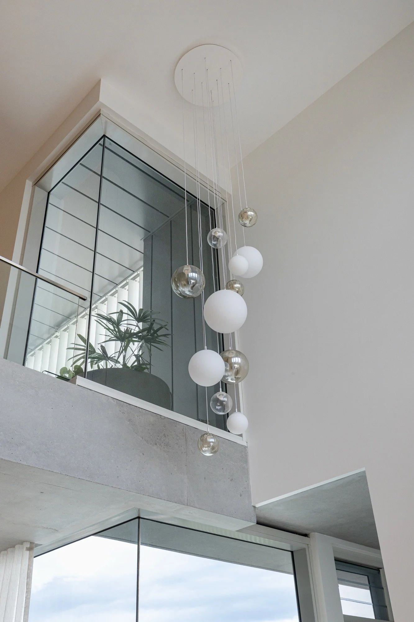 Feature lighting in high ceiling void spaces in the Camp Hill home 'The Concrete Canvas' by Brisbane interior designer Melinda Fritz