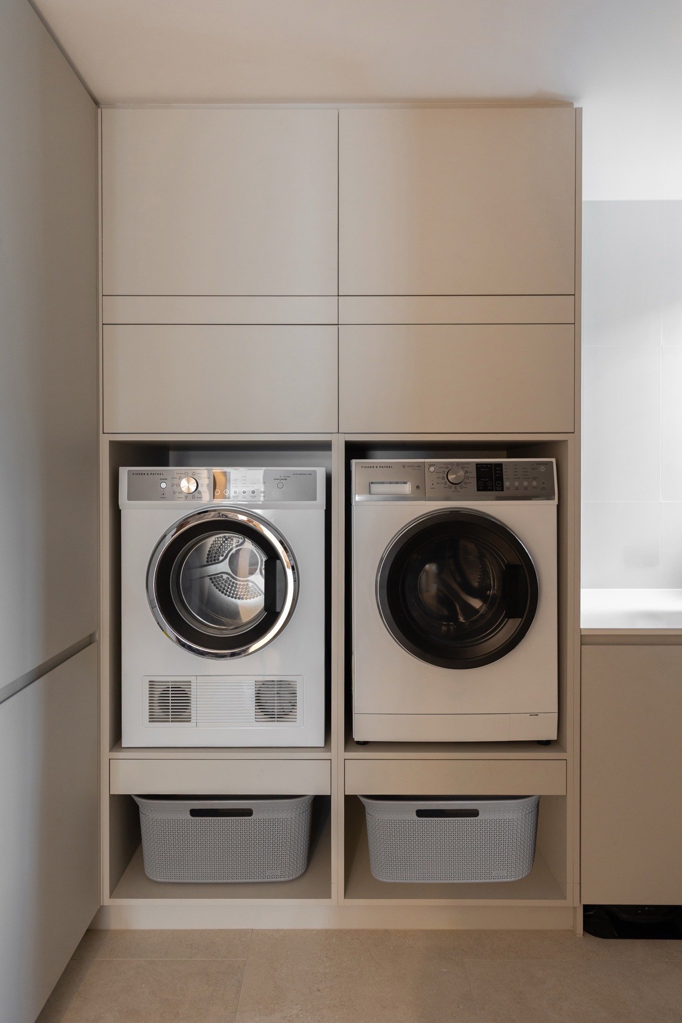 Clean custom laundry joinery for washer and dryer in the Camp Hill home 'The Concrete Canvas' by Brisbane interior designer Melinda Fritz