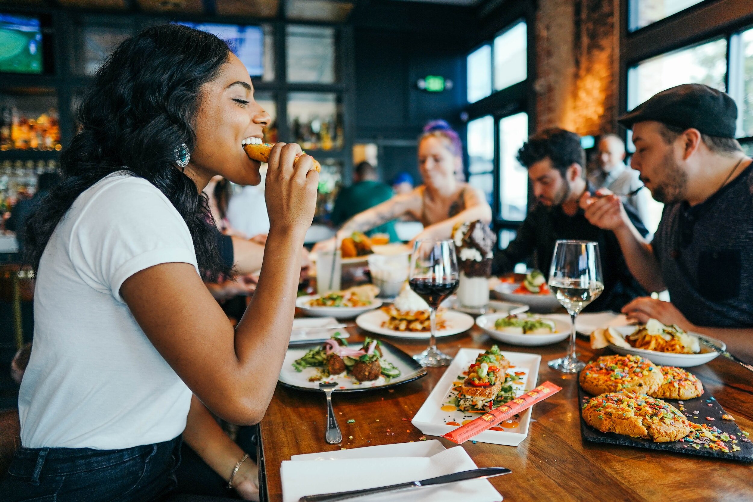 People indulging in food and sushi at a popular restaurant