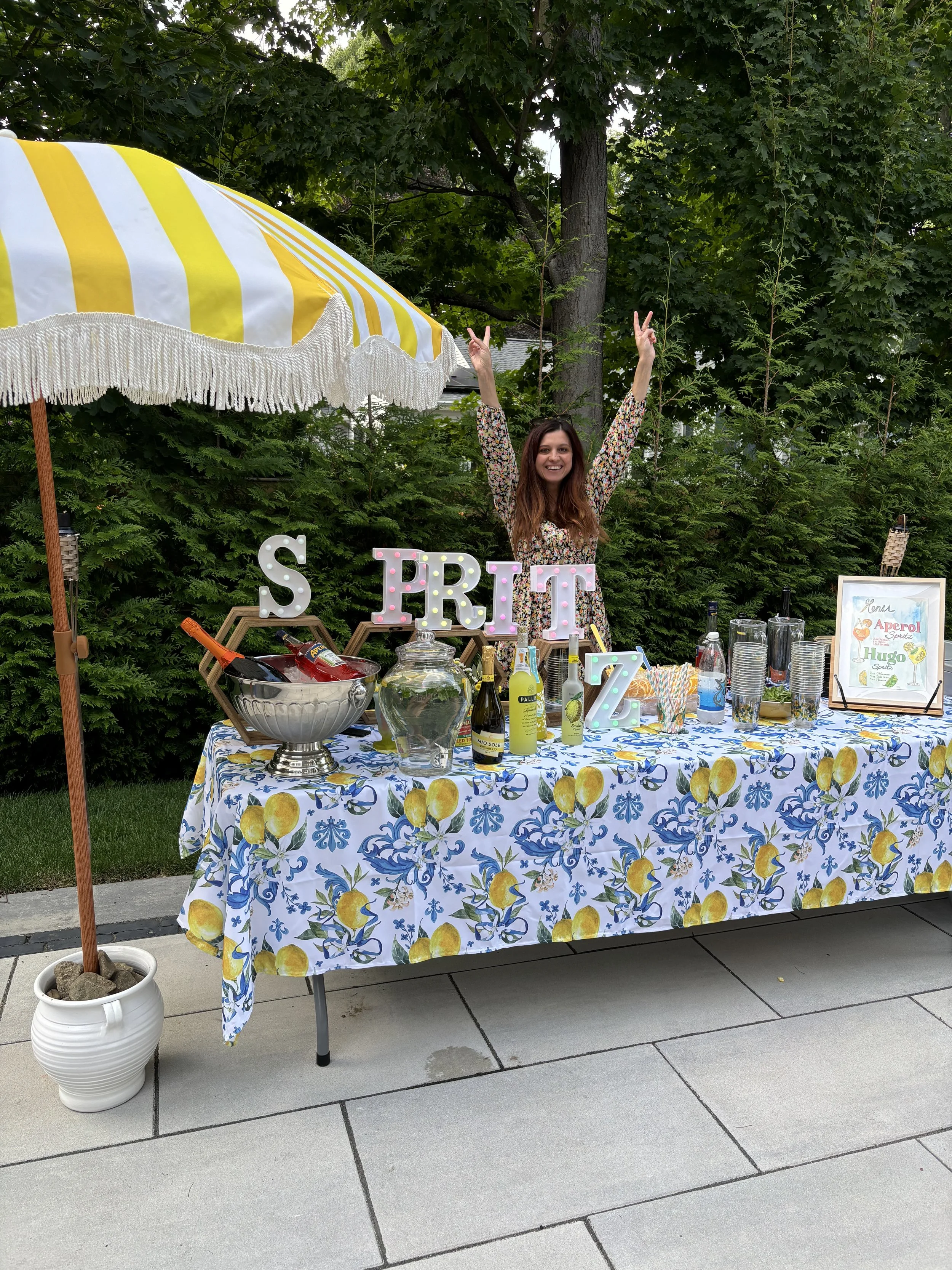 Lia Gurin, founder and CEO of The Scoop Brands bartending at an Amalfi Coast themed party in Needham, Massachusetts