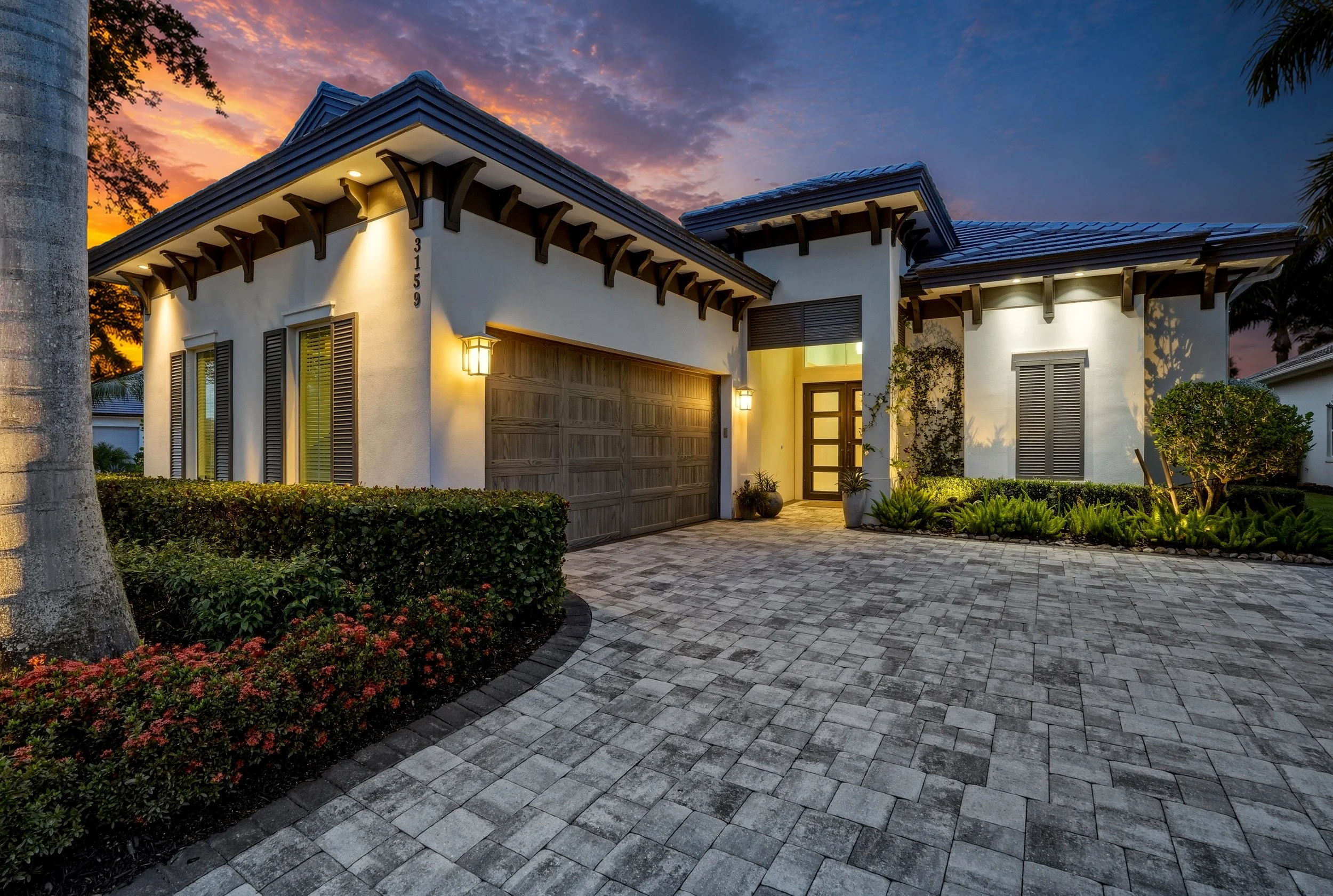 Twilight real estate photo in Naples, FL with exterior and landscape lighting on, by Gulfside Media.