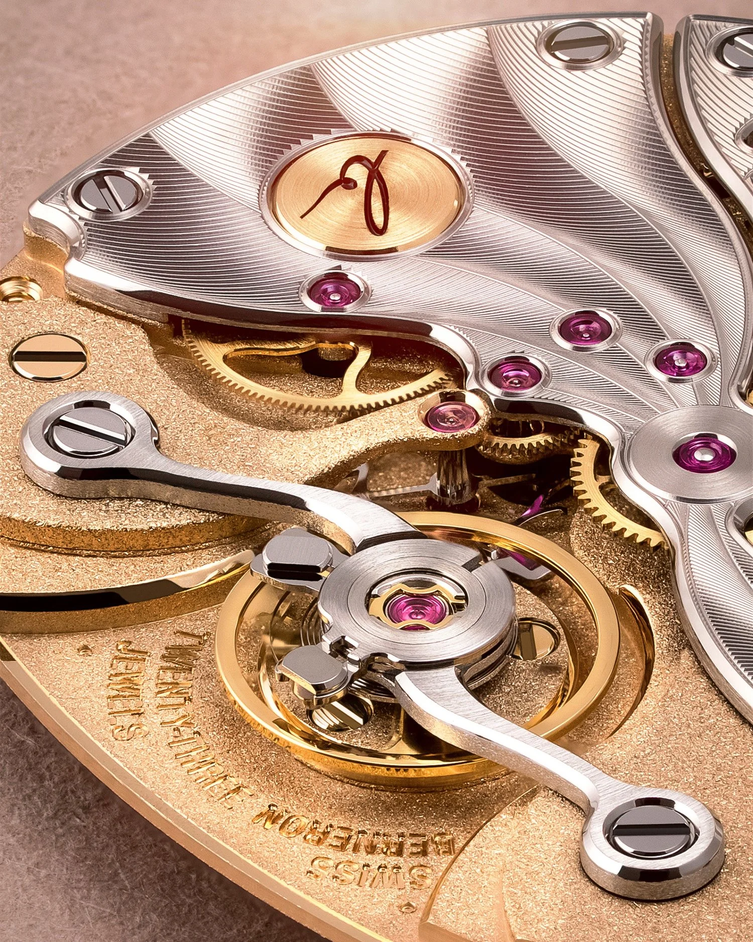Close-up of a luxury watch movement with engraved metal parts, gears, and purple jewel bearings.