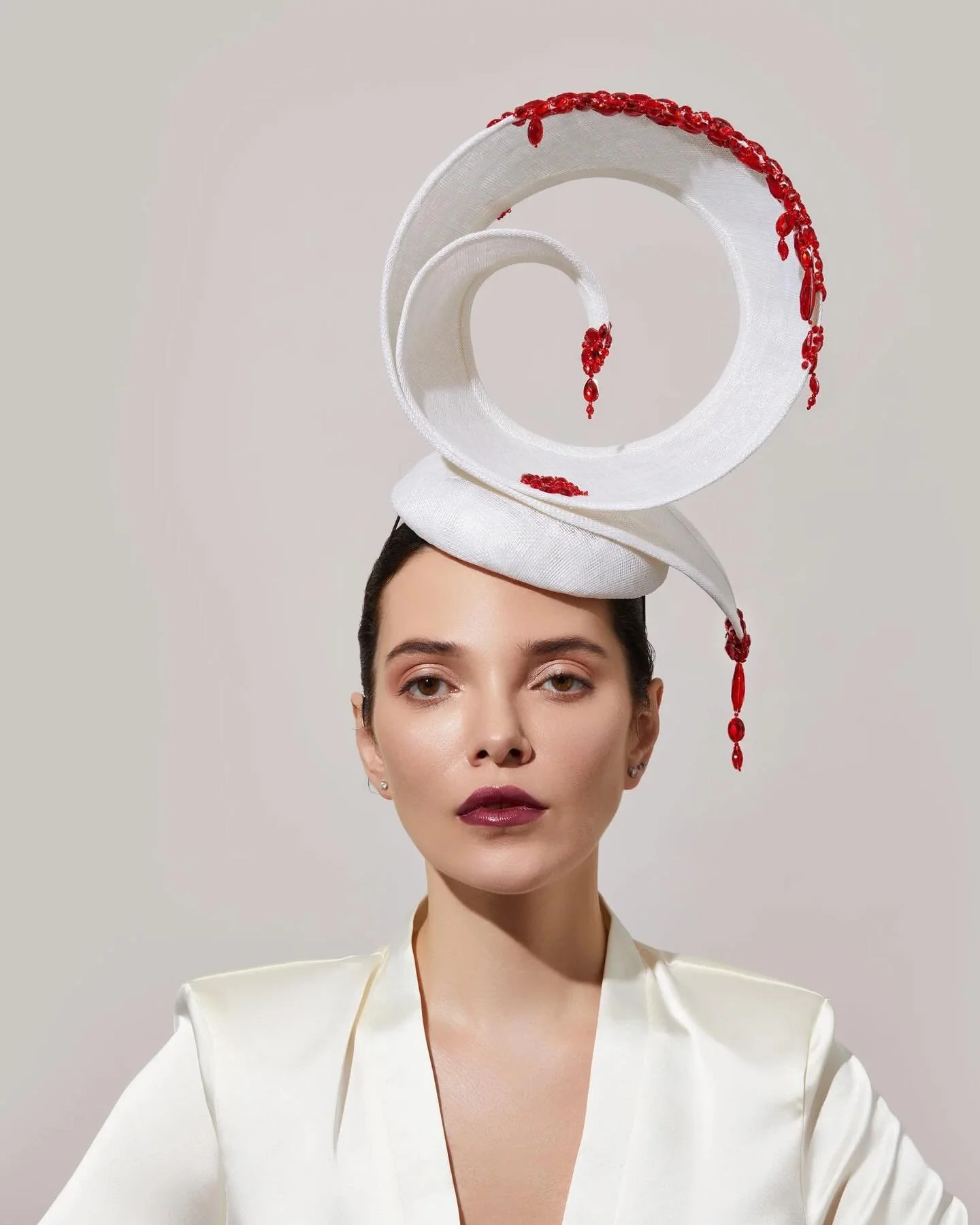 This is one of my favourite hats, created in white and red, perfect for this season, and made from sinamay and hand-beaded red crystals. This can be made in any colour and is perfect for # RoyalAscot horse racing. 
All of our hats are handmade in the