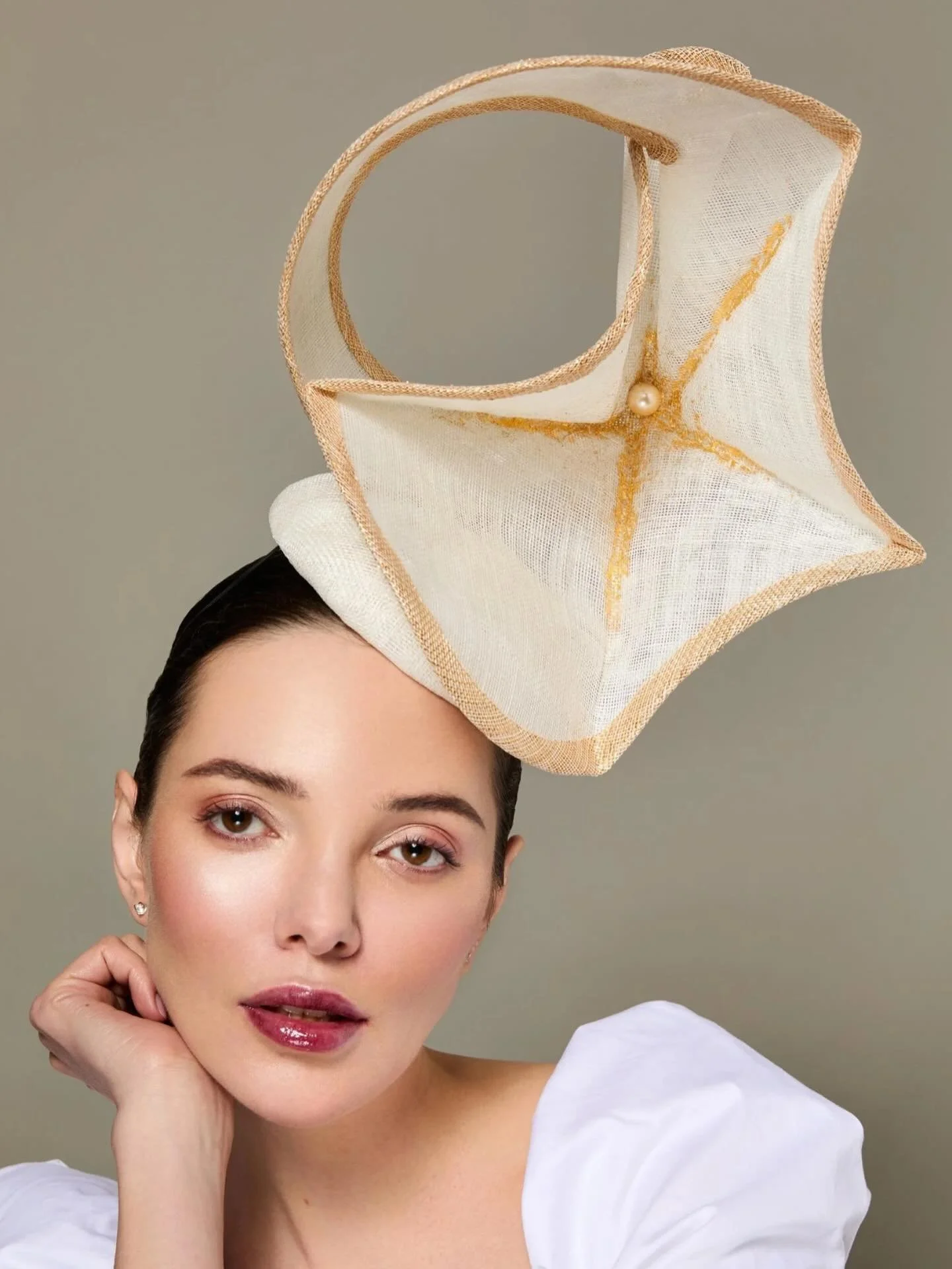 This is one of my more dramatic sculptural pieces made from Sinamay straw, adorned with 24k goldleaf and pearl beads. 
.
This can be made in any colour and is perfect for #RoyalAscot or glamorous fashion event or wedding.
All of our hats are handmade