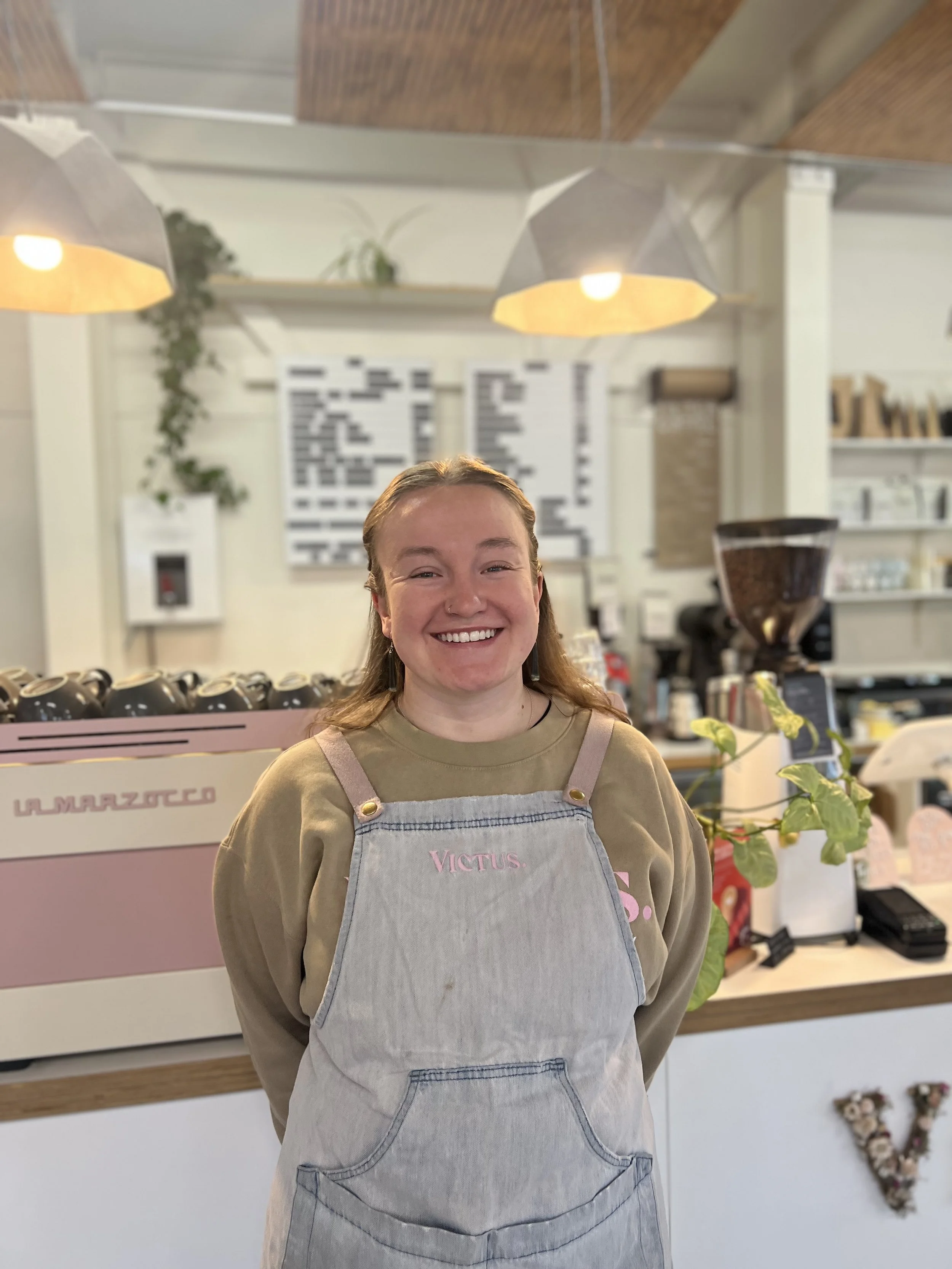 Girl standing in modern cafe with a striped shirt