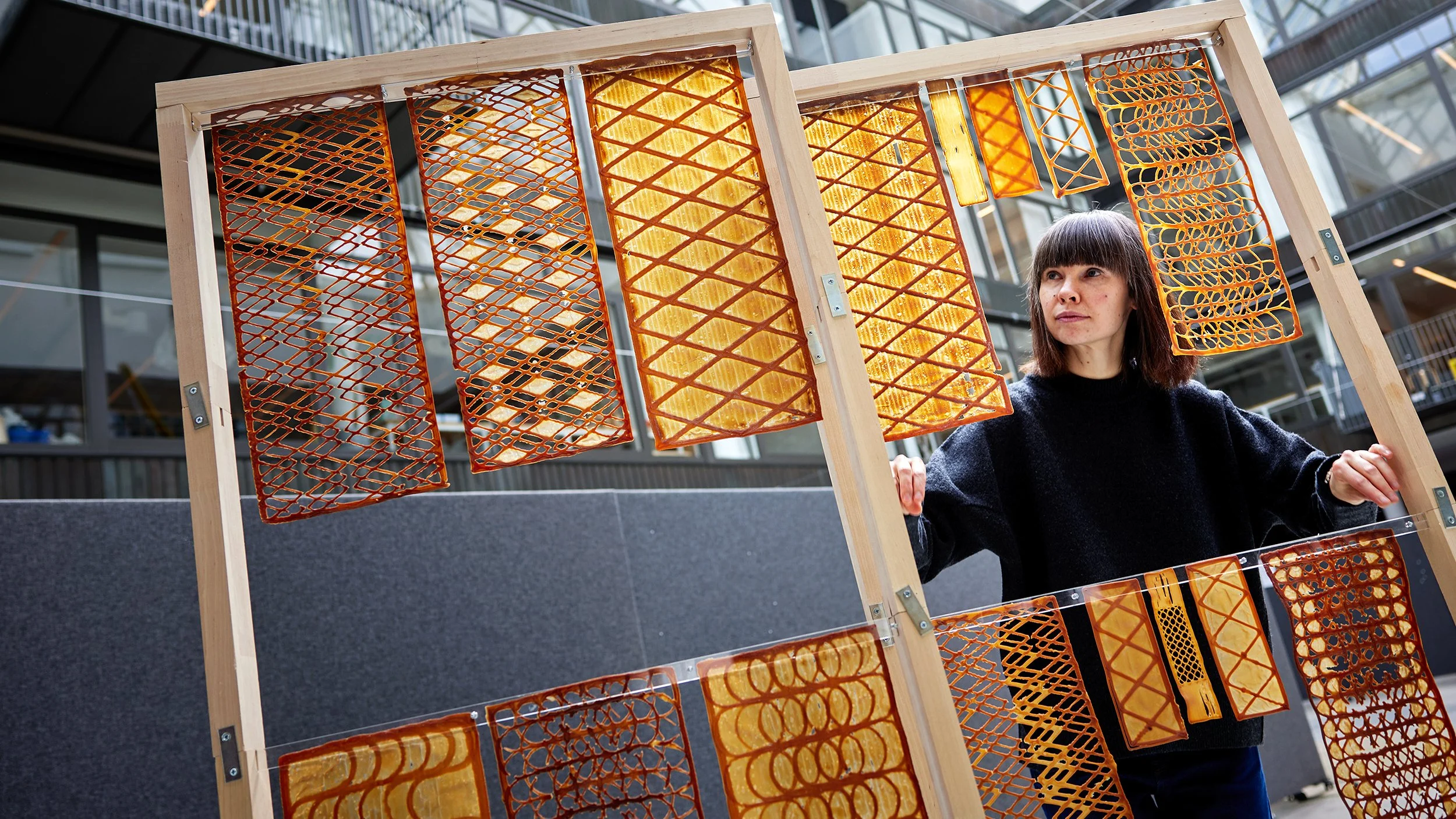 La arquitecta Malgorzata Zboinska examina paneles impresos en 3D con biomaterial de levadura. Su diseño permite modular la entrada de luz natural y explorar nuevas soluciones sostenibles para interiores.