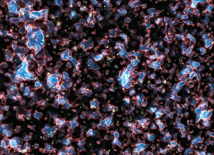 Simulación de la época de la reionización del universo primitivo. Las regiones azules representan gas ionizado por la radiación ultravioleta de las primeras galaxias, mientras que las zonas oscuras contienen hidrógeno neutro.